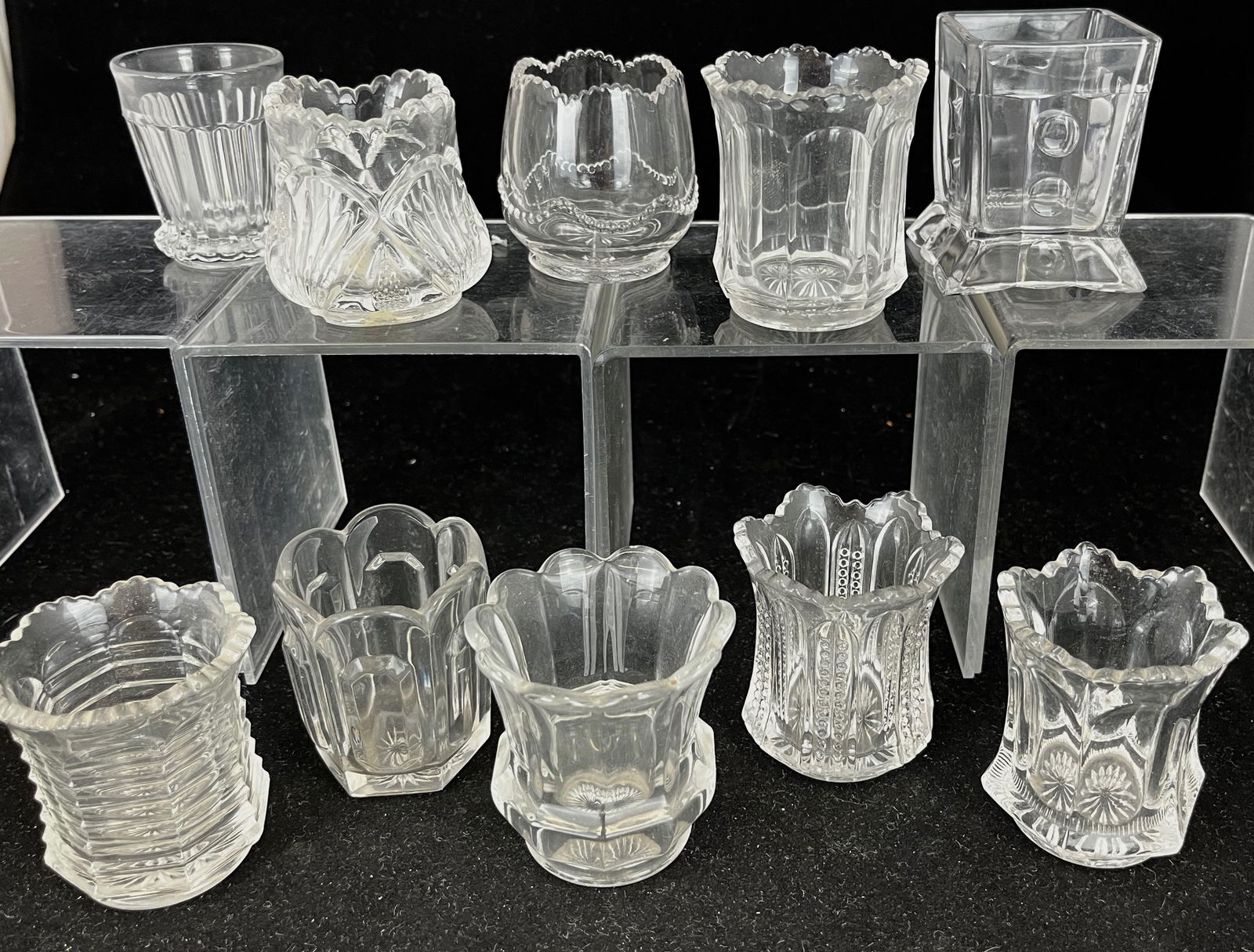 10 Heisey clear toothpick holders: 10 Heisey clear toothpick holders various designs; tallest 2.5"; CONDITION: good with minor wear.