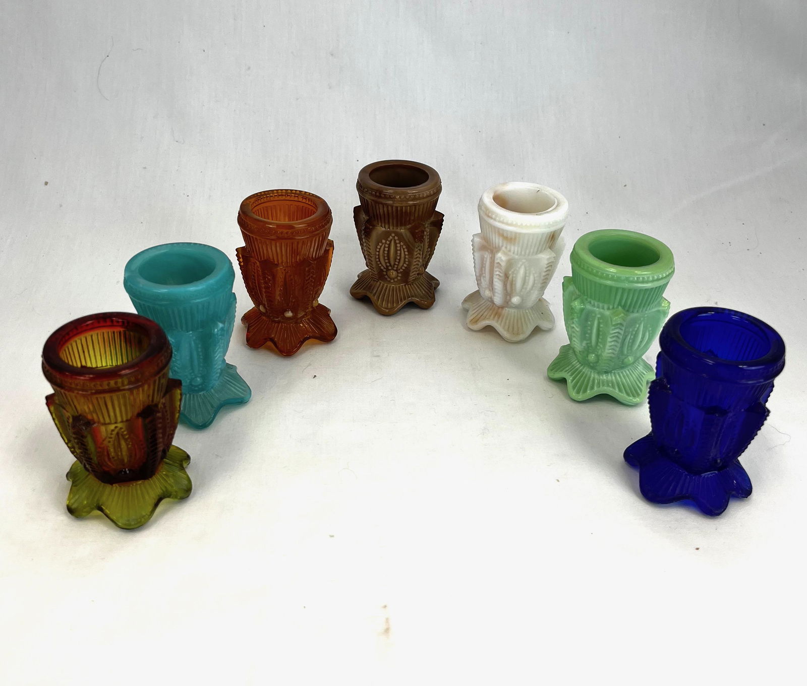 Grouping of seven Cacti toothpicks: Seven Cactus pattern toothpick holders various colors and makers; 2 5/8" ht. CONDITION: good with minor wear.