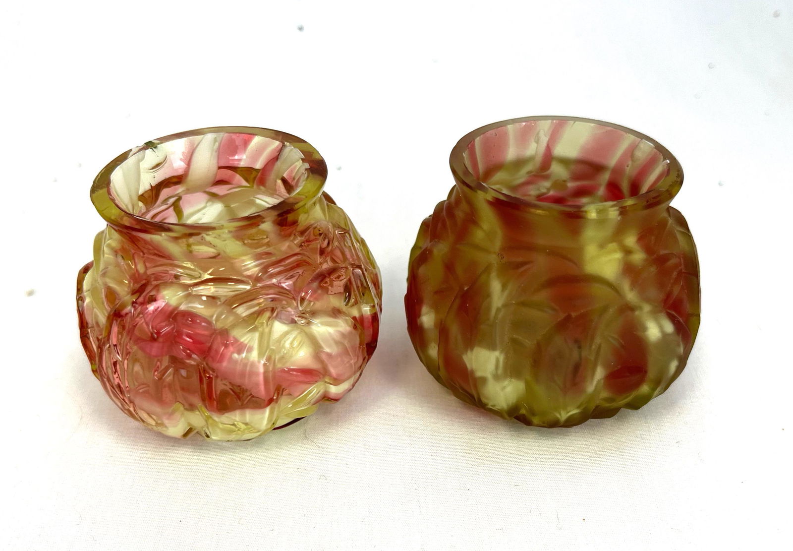 Two Northwood toothpick holders: Two Early American Northwood toothpick holders, Ruby and Canary Spatter ware in Leaf mold, one translucent and one frost; 2" ht. CONDITION: good with minor wear, one with translucent has chip to rim.
