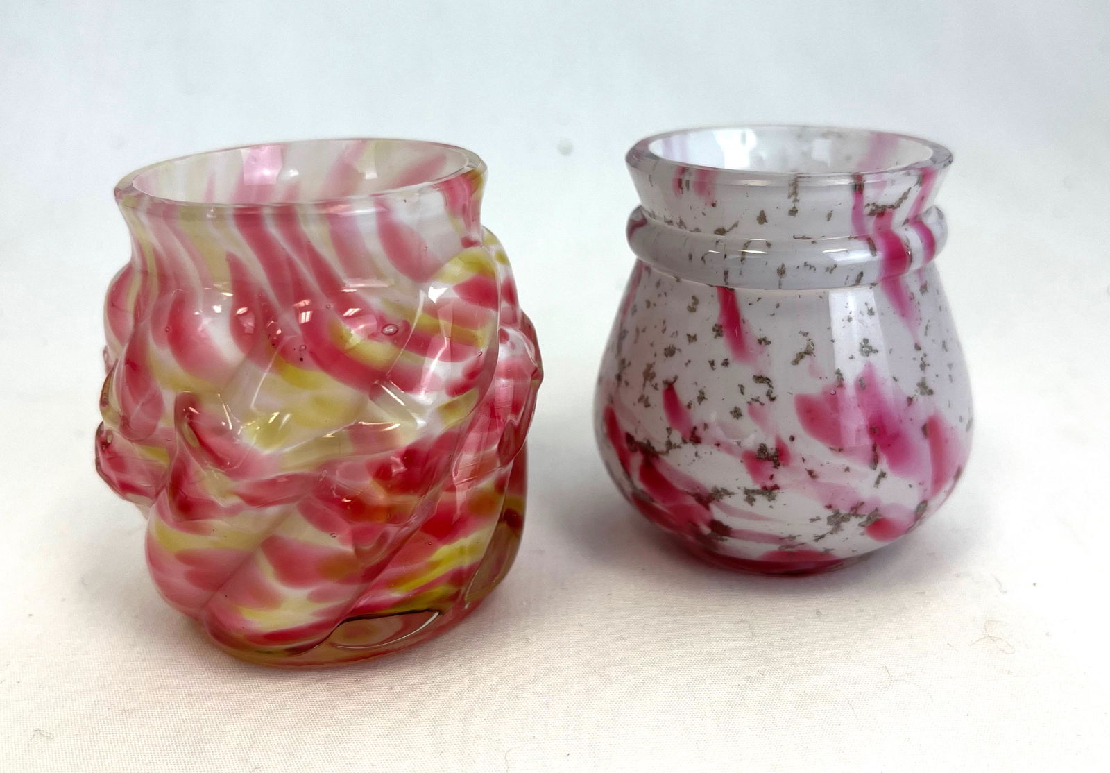 Two Northwood toothpick holders: Two Northwood Rainbow Spatter one Royal Ivy and one Ring Neck; 2 1/4" ht. Literature: Bredehofts/the Sanfords - Glass Toothpick Holders, Second Edition, p. 163. CONDITION: good with minor wear.