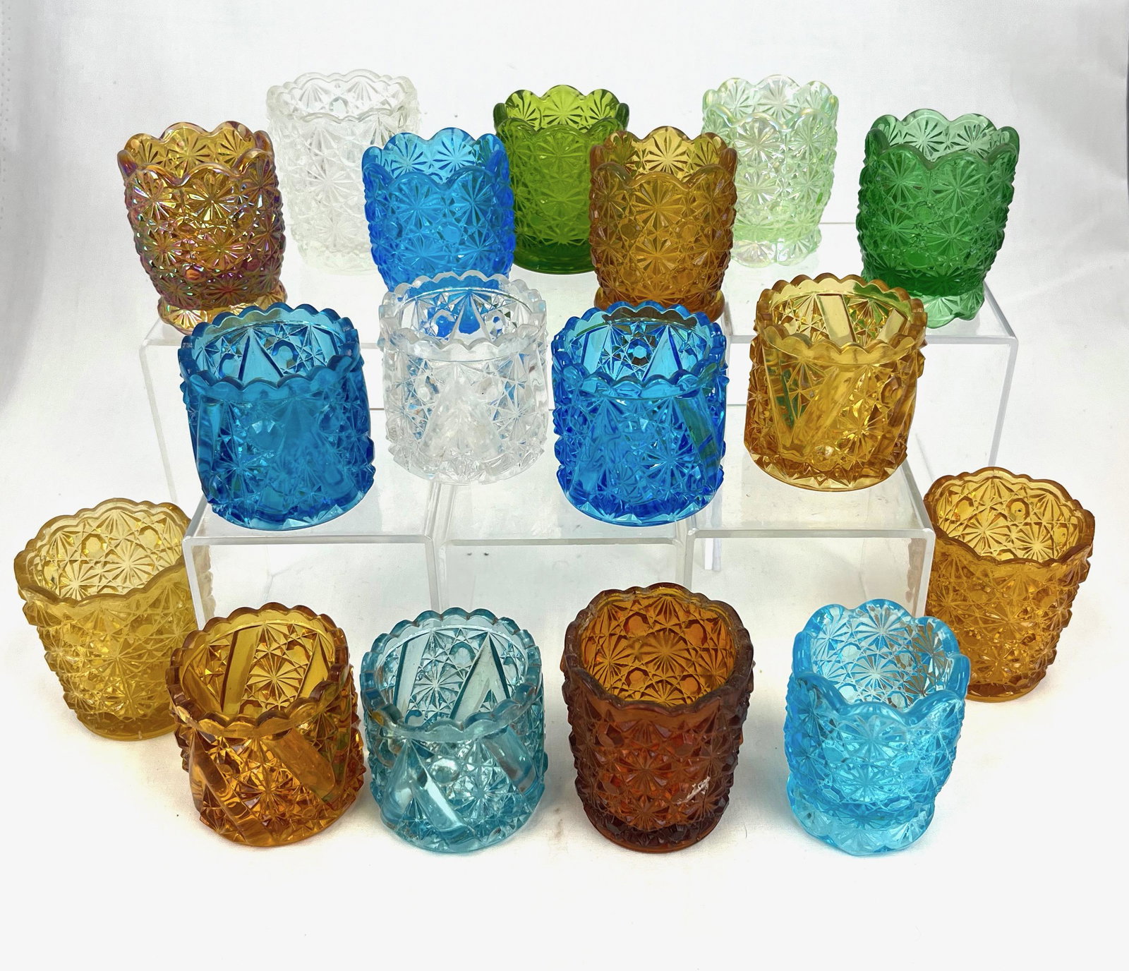 Grouping of 17 toothpicks: Grouping of 17 Daisy & Button toothpick holders, various makers and colors; tallest 2.5"; CONDITION: good with minor wear.