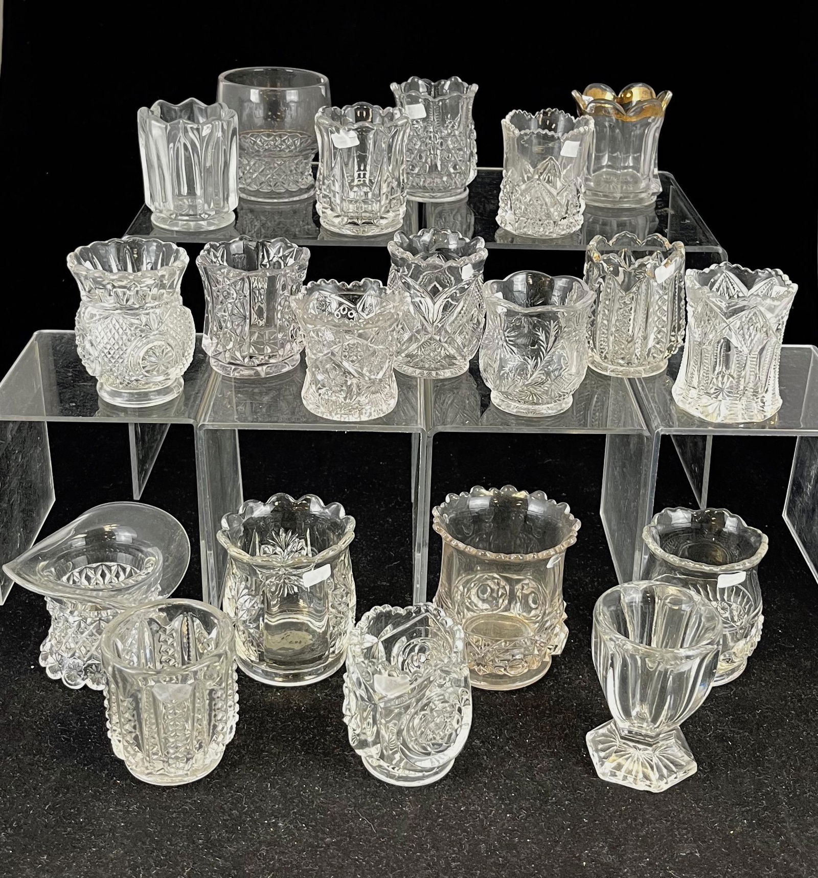 20 EAPG clear assorted toothpicks: A grouping of 20 clear toothpick holders various makers and patterns; tallest 2 7/8". CONDITION: good with minor wear.