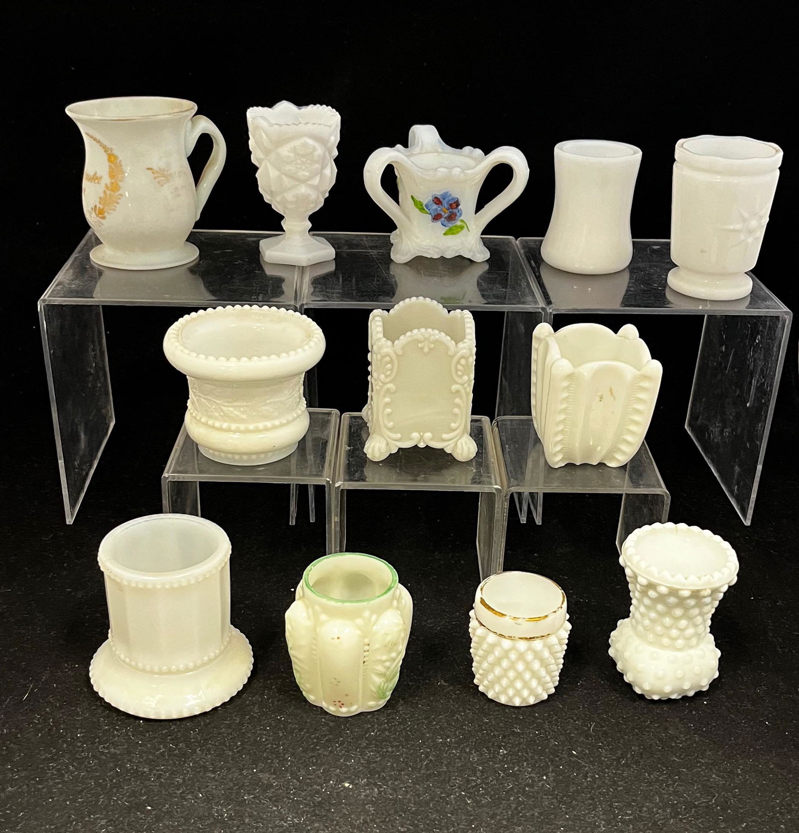 Group of 12 milk glass toothpicks: Group of 12 milk glass toothpick holders various makers and patterns; tallest 3". CONDITION: good with minor wear