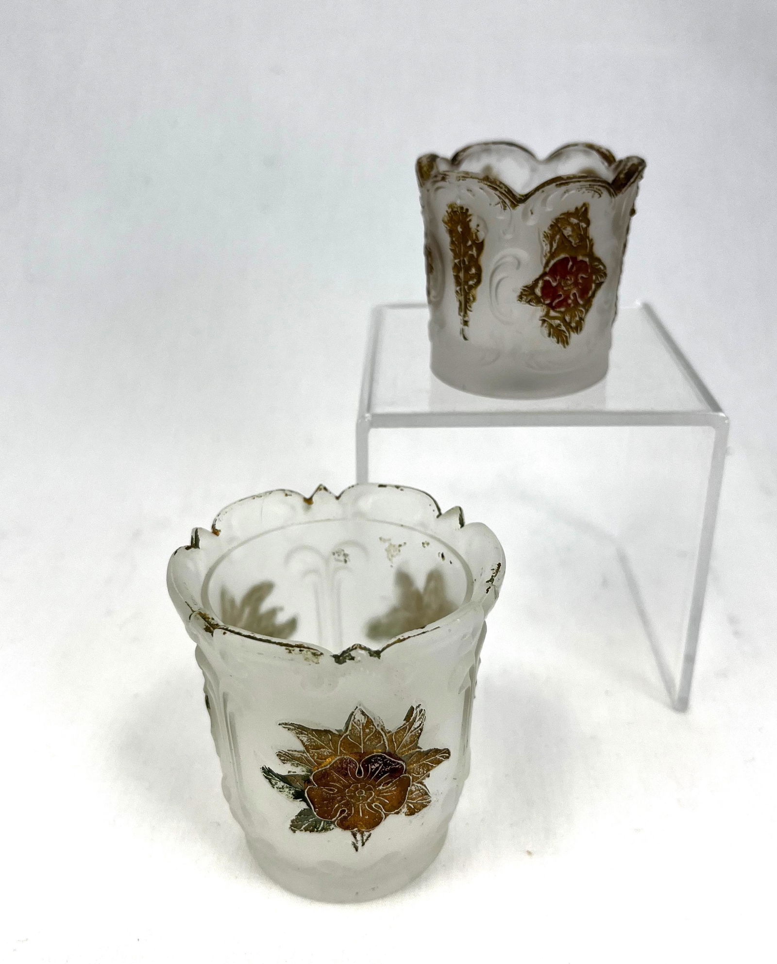 Two Wild Rose with Bowknot toothpick: Two clear with satin finish Wild Rose with Bowknot toothpick holders; tallest 2 5/8". CONDITION: good with minor wear.