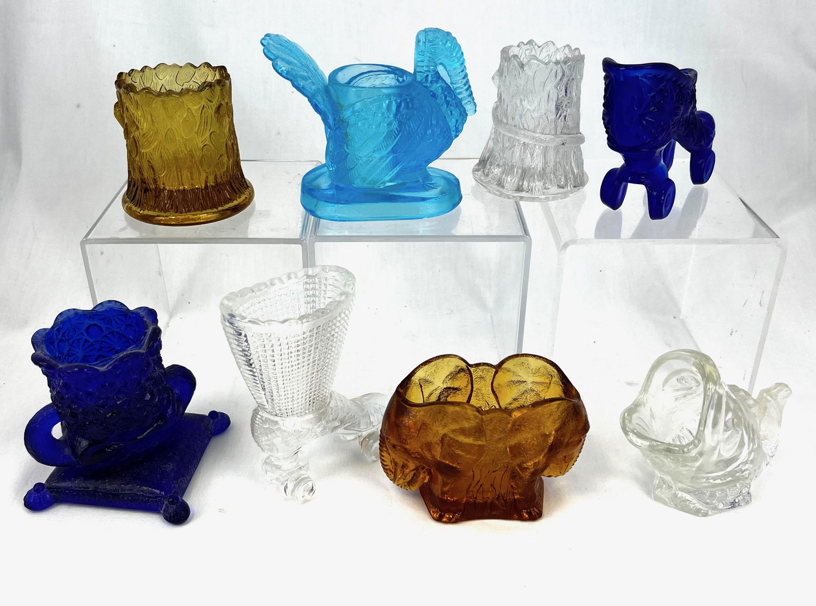 Group of eight figural toothpicks: Group of eight contemporary figural toothpick holders, various makers and colors, including two roller skates, fish, turkey, double elephant head, cat on pillow, and snake on stump; tallest 4"; CONDIT