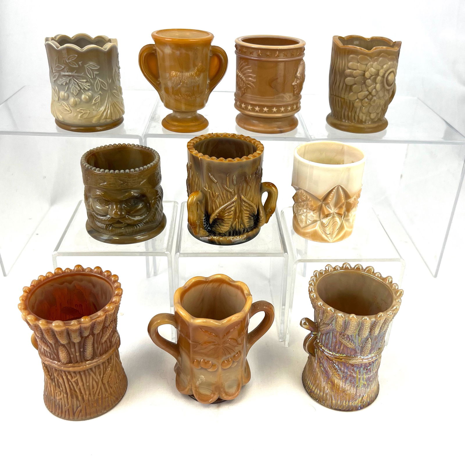 Group of 10 toothpick holders: Group of 10 chocolate and caramel predominately Joseph Sinclair toothpick holders, various patterns; tallest 3"; CONDITION: good with minor wear.