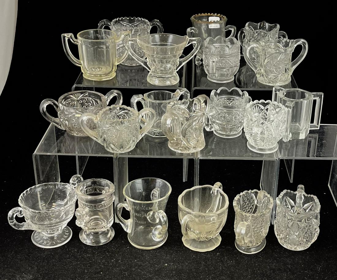 20 EAPG clear assorted toothpicks: 20 EAPG clear toothpick holders with handles various makers and patterns; tallest 2". CONDITION: good with minor wear.