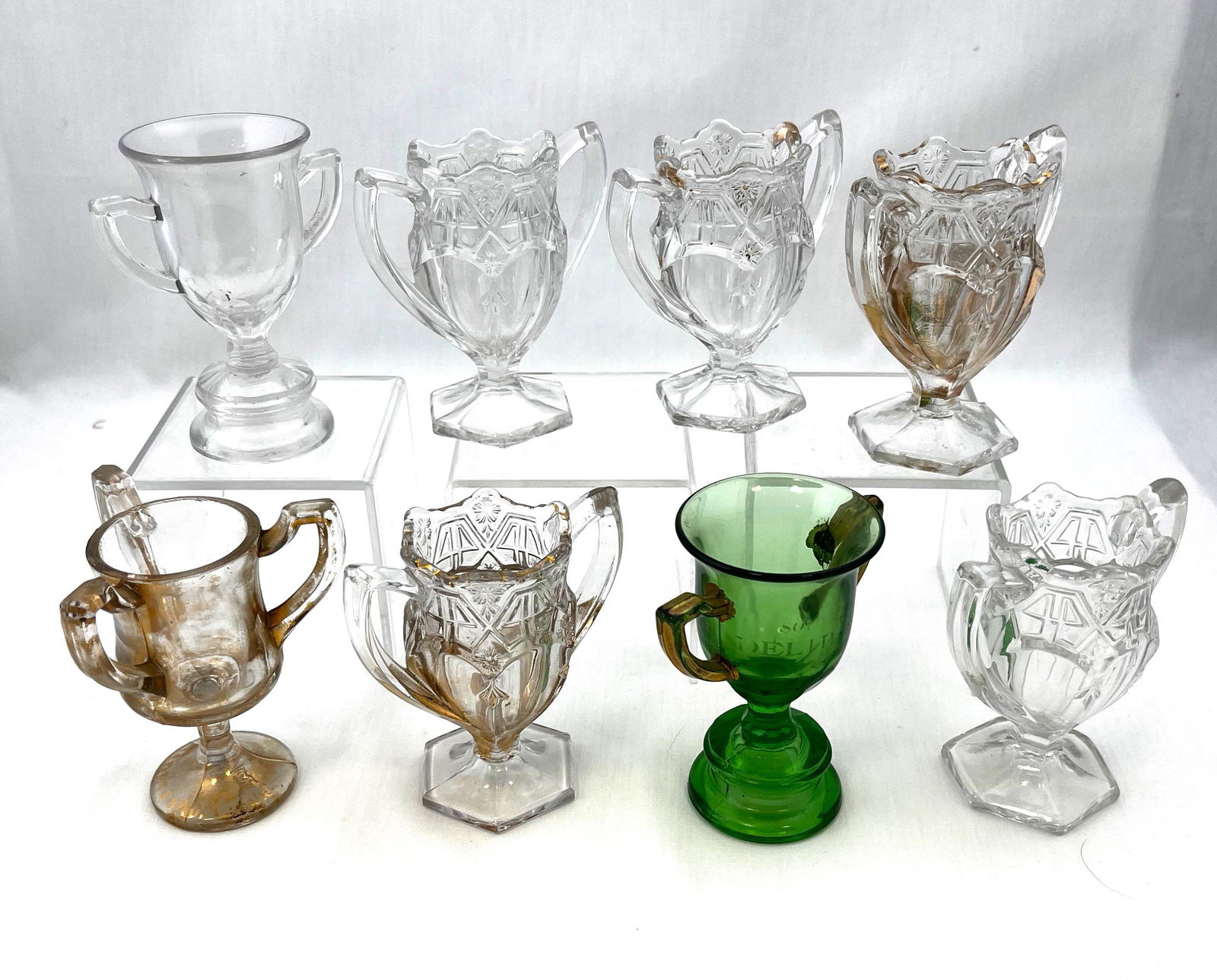 Eight EAPG toothpick holders: Eight EAPG toothpick holders primarily U.S. Glass Co., two Trophy one clear, one green with gold dŽcor; three clear Paneled, two clear with light marigold luster; and a clear with gold dŽcor three h