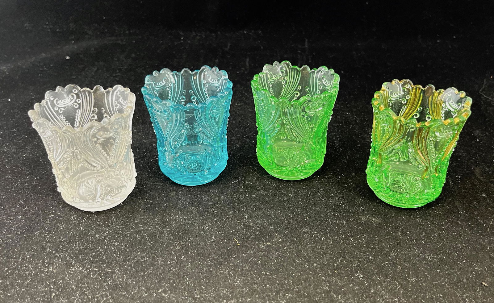 Four Jefferson Idyll toothpicks: Four Jefferson Idyll toothpicks, on green with gold dŽcor, one clear, one green, one blue; 2.5" ht. Literature: Bredehofts/the Sanfords - Glass Toothpick Holders, Second Edition, p. 218. CONDITION: g