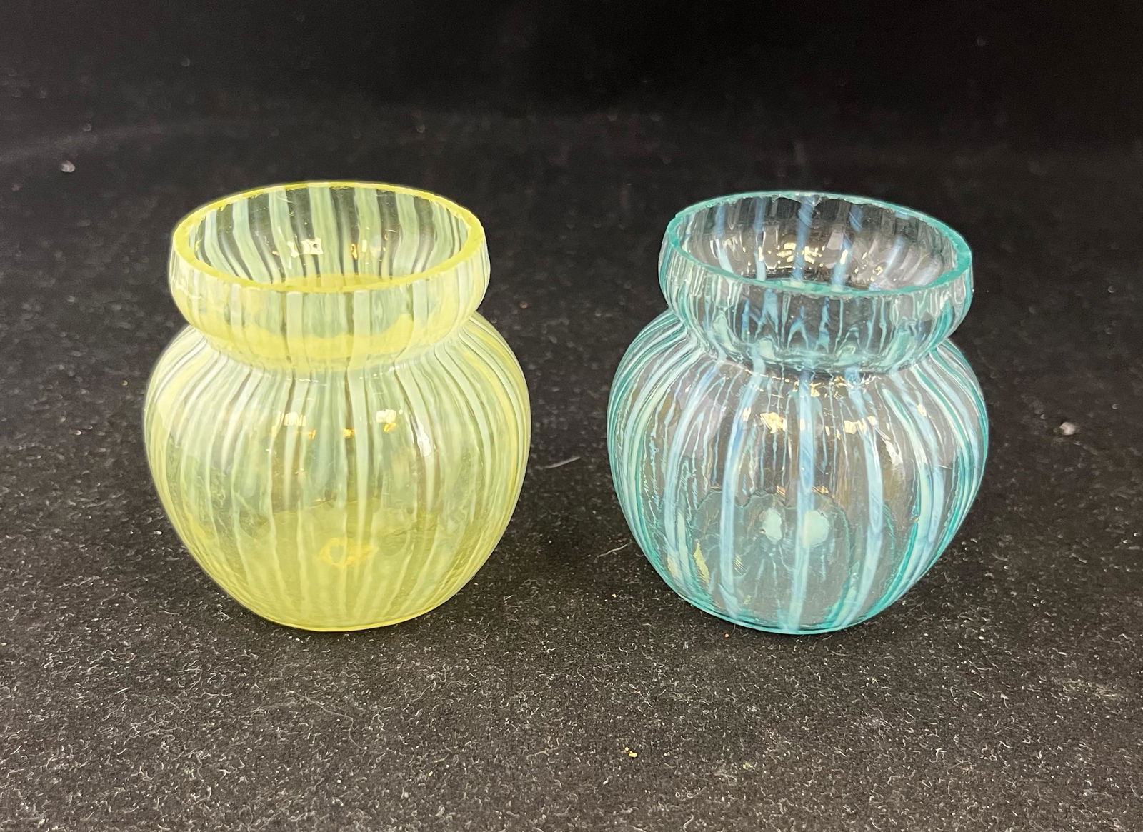 Two Opalescent Stripe toothpicks: Two Opalescent Stripe toothpick holders maker unknown, one clear opalescent and one blue opalescent; 2.5" ht. CONDITION: good with minor wear.