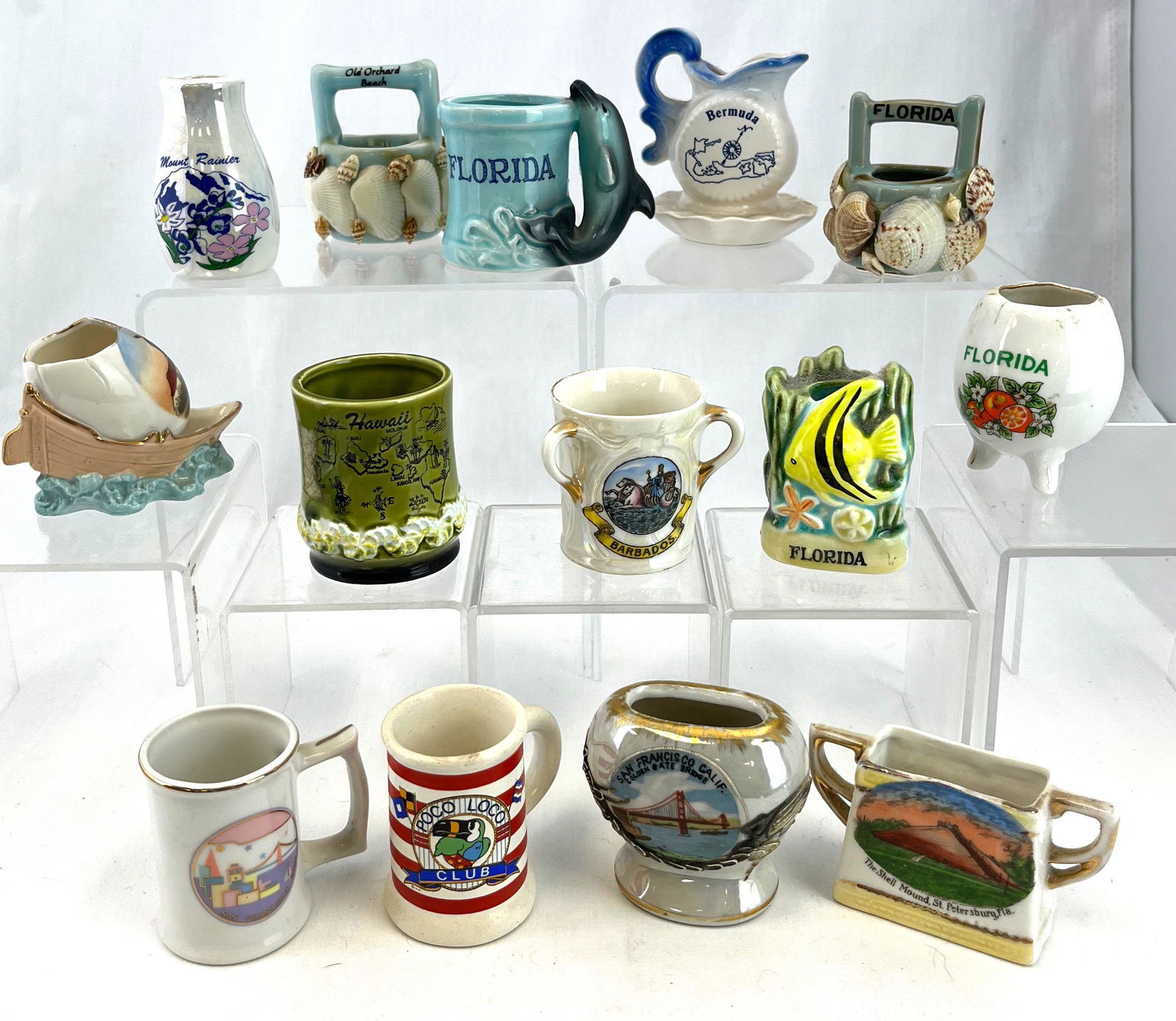 14 vacation destination toothpicks: 14 vacation destination toothpick holders including Bermuda, Hawaii, Barbados, Holland, Florida, and Maine; tallest 2 3/8". CONDITION: good with minor wear, Florida three footed has small crack at rim