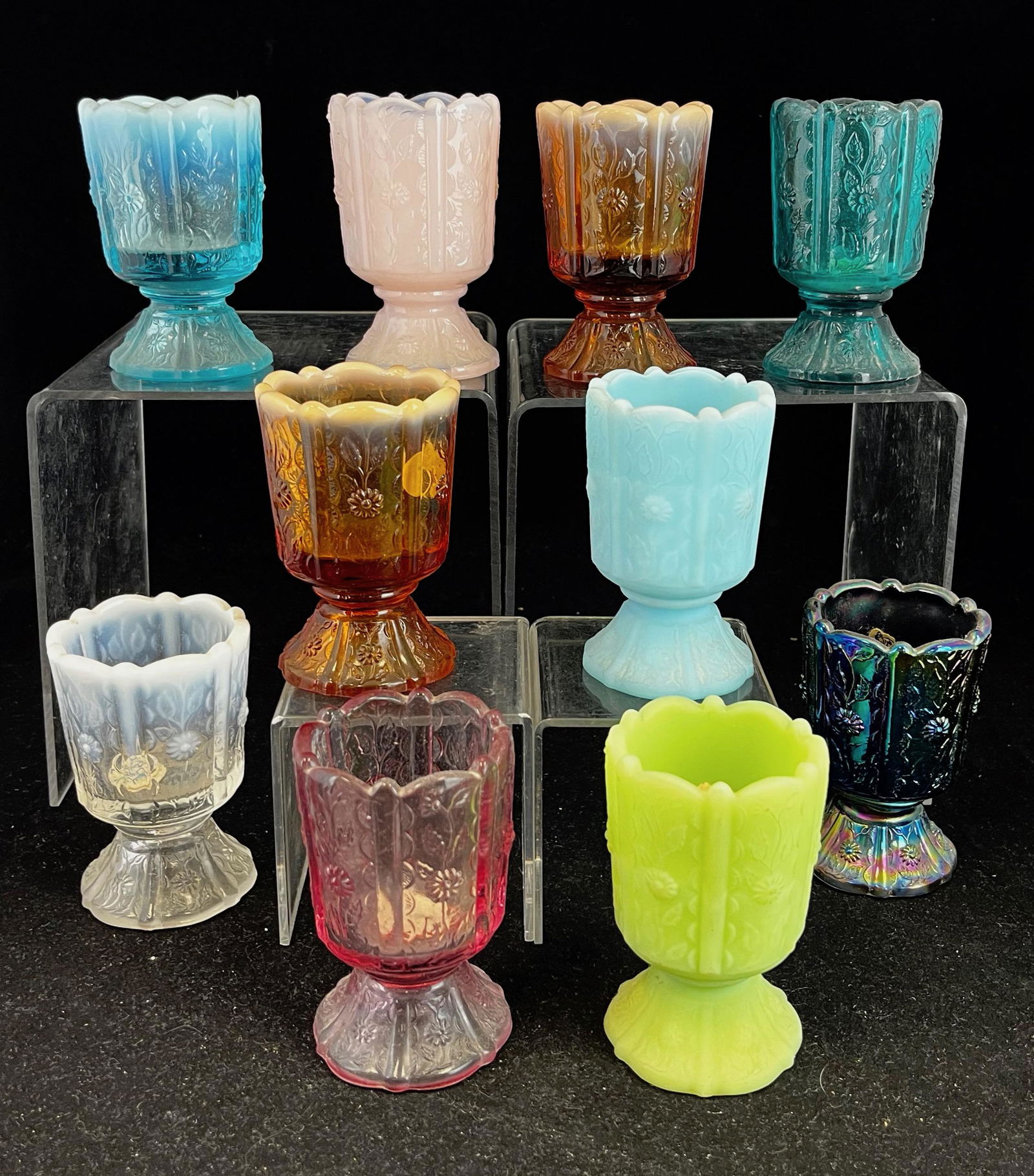 Group of 10 Fenton toothpick holders: Group of 10 Fenton Paneled Daisy various colors including an amethyst carnival, opalescent, and satin; 3.5" ht. CONDITION: no defects noted.