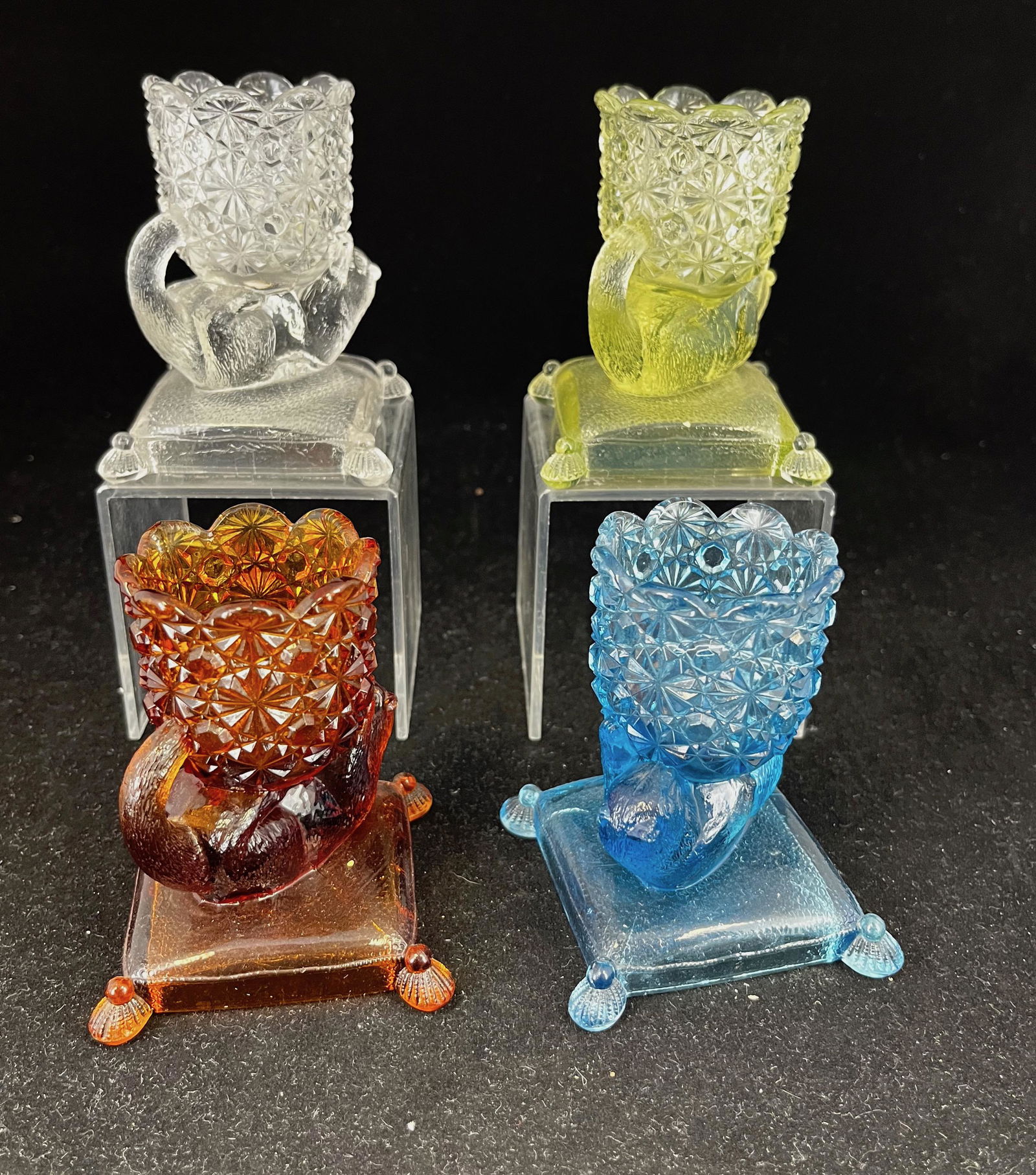 Three Kitten on Pillow EAPG toothpicks: Three Richard & Hartley Kitten on Pillow EAPG toothpick holders one each of original color; 3.5" ht. Literature: Bredehofts/the Sanfords - Glass Toothpick Holders, Second Edition, p. 168. CONDITION: n