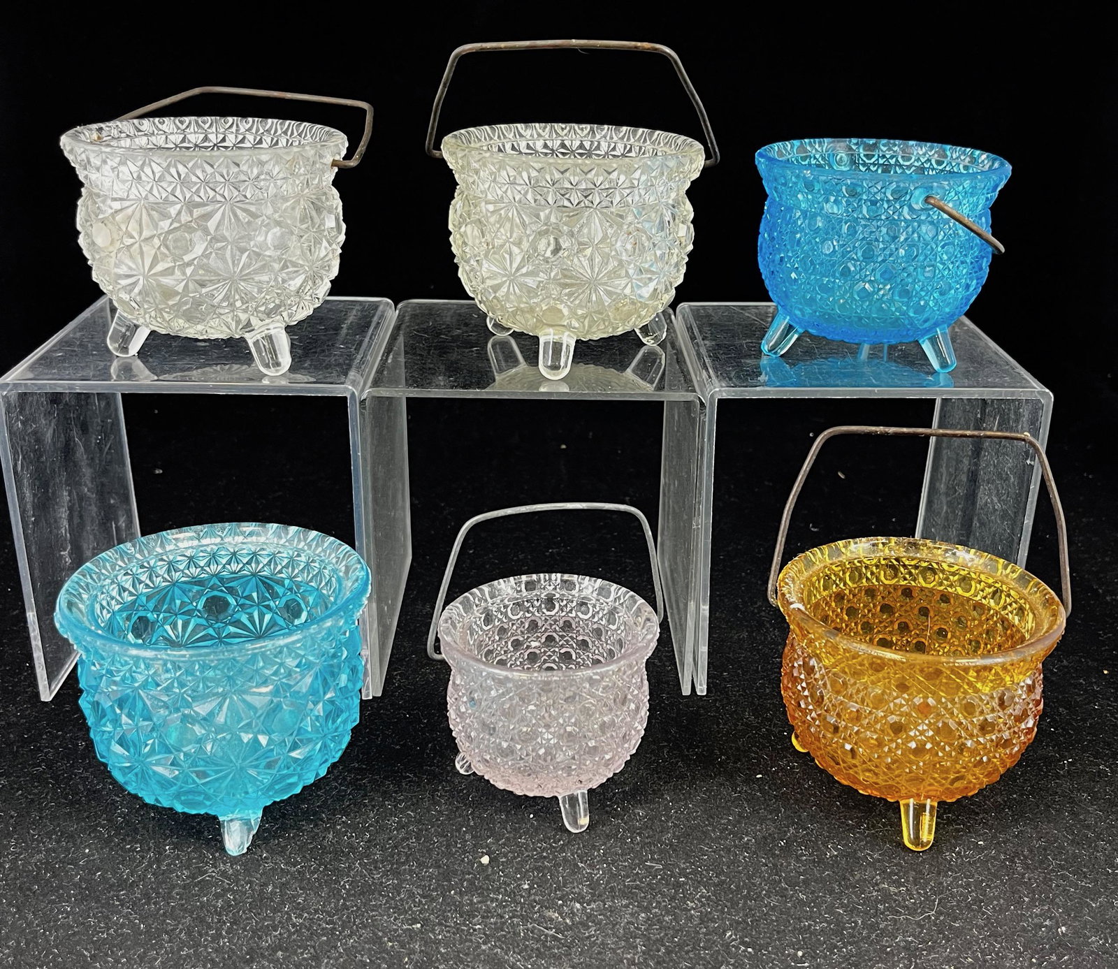 Six EAPG Kettle mustards: Six EAPG Kettle mustards various makers and patterns including an amber, blue, and small lavender Fine Cut and two clear Daisy & Button and a blue Daisy & Blue; tallest 2 3/8". CONDITION: blue Daisy &
