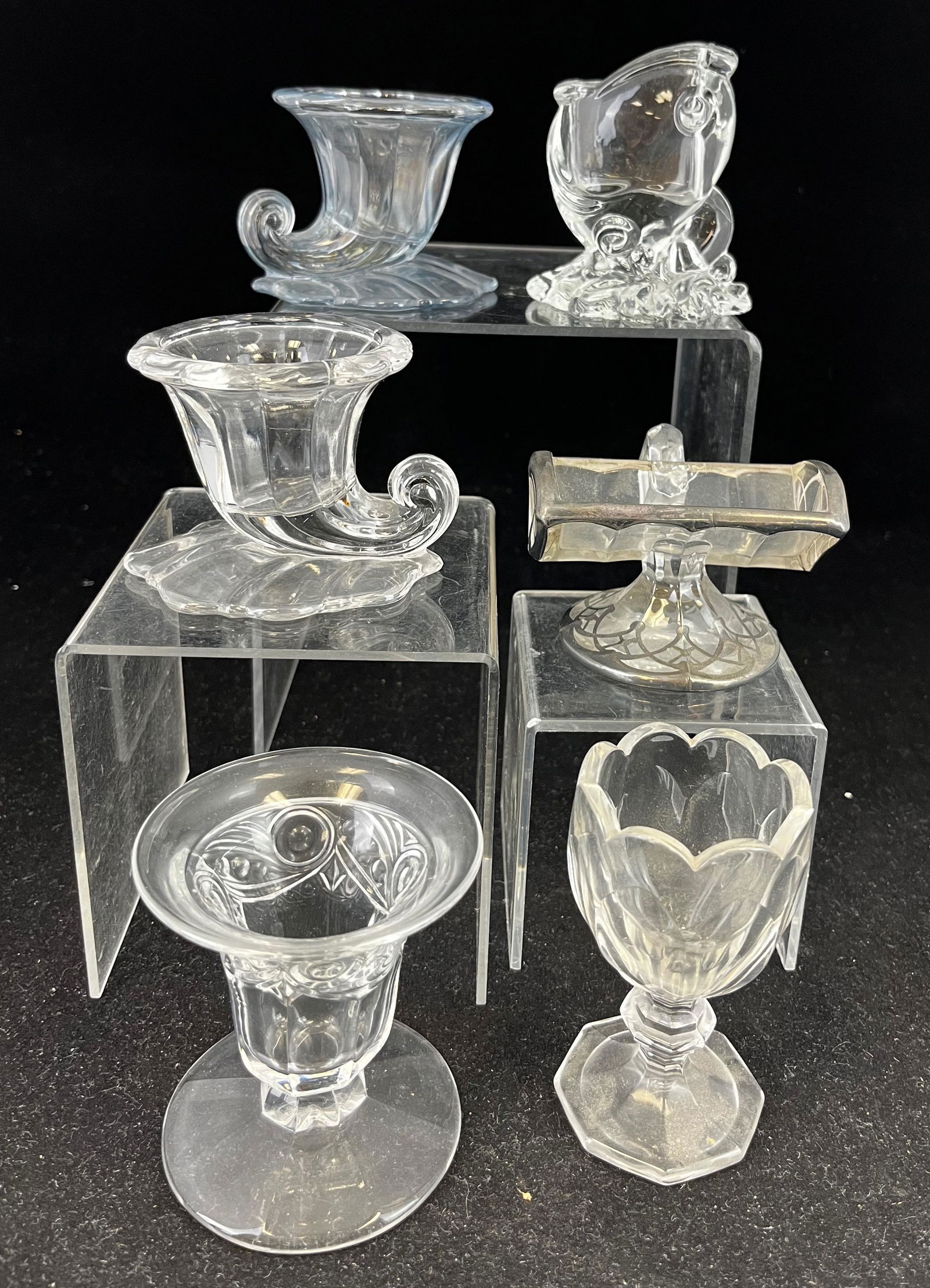Group of six Heisey clear toothpicks: Group of six Heisey clear toothpick holders of various patterns including a Puritan, two Shell, and a Dolphin; tallest 3.5". CONDITION: good with minor wear.