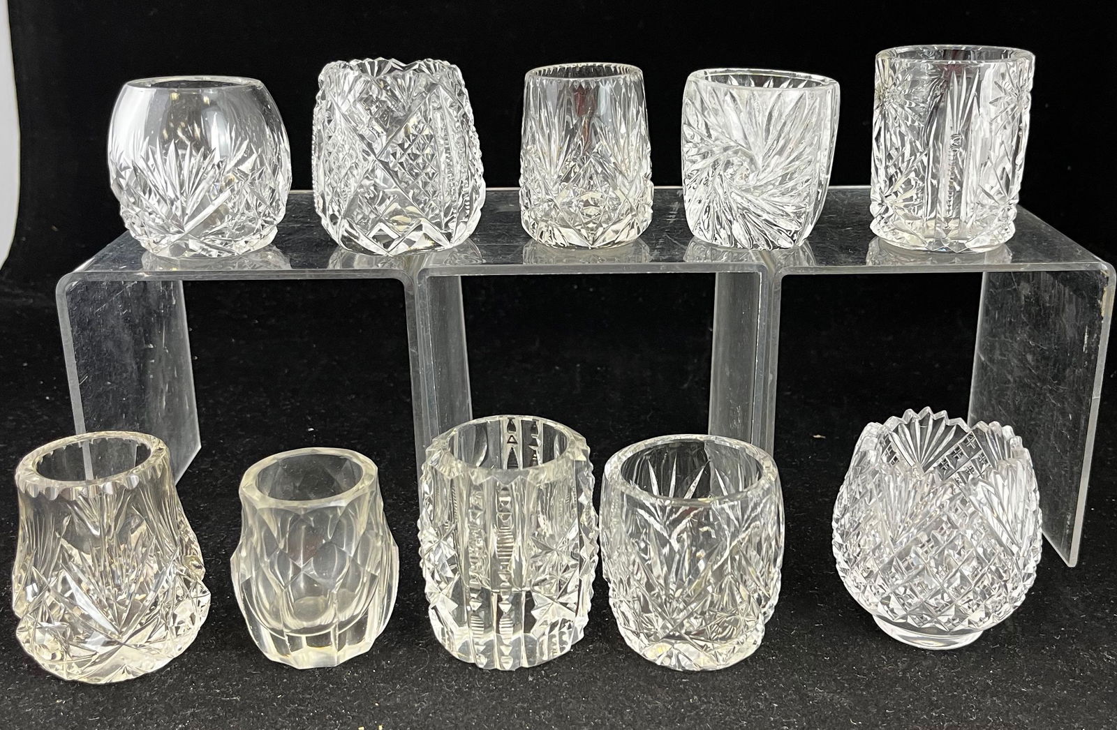 Group of 10 cut glass toothpicks: Group of 10 cut glass toothpick holders, various makers and patterns including Hobstar & Fan, Star & Fan, Daisy Trio, 4 Panel with Star 7 Thumbprint, and Cyrene type; tallest 2 3/8". CONDITION: minor