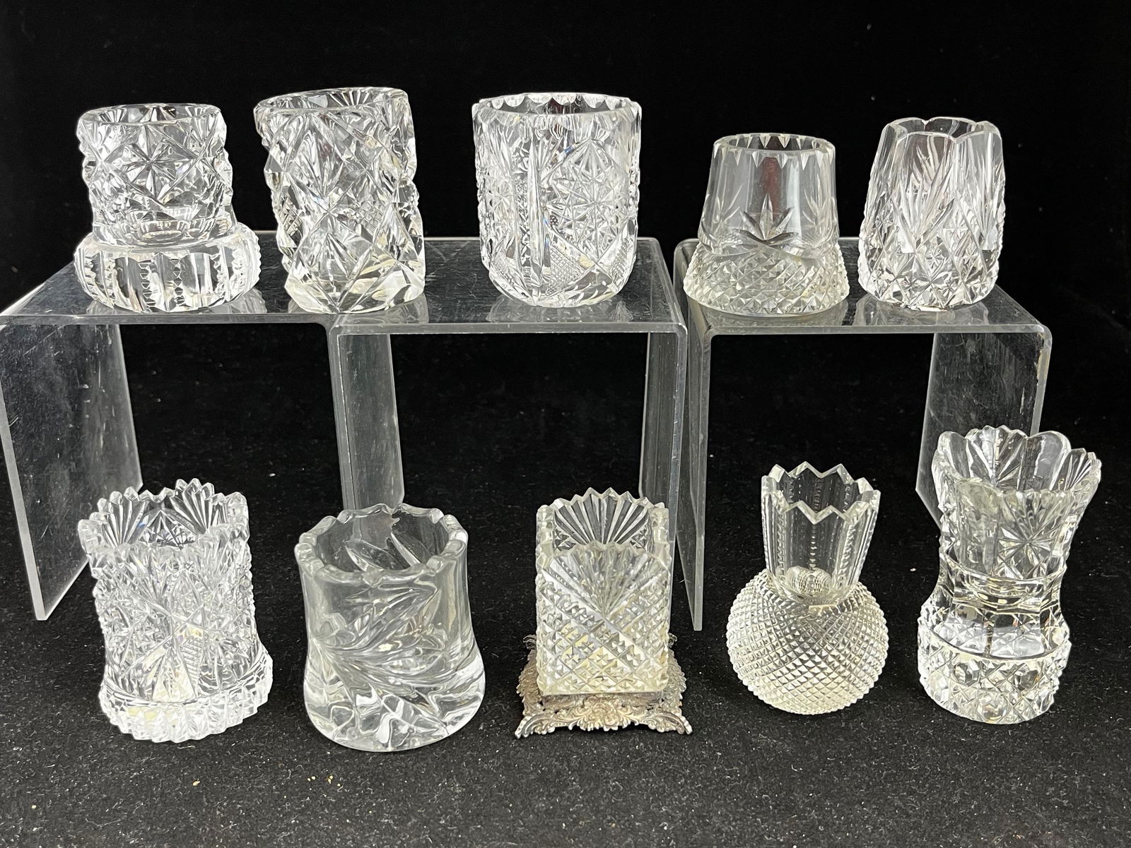 Group of 10 cut glass toothpicks: Group of 10 cut glass toothpick holders, various makers and patterns including Notched with Prisms, Hobstar & Ribbed Base, Pineapple & Fan, and square Pineapple & Fan in metal base; tallest 3". CONDIT