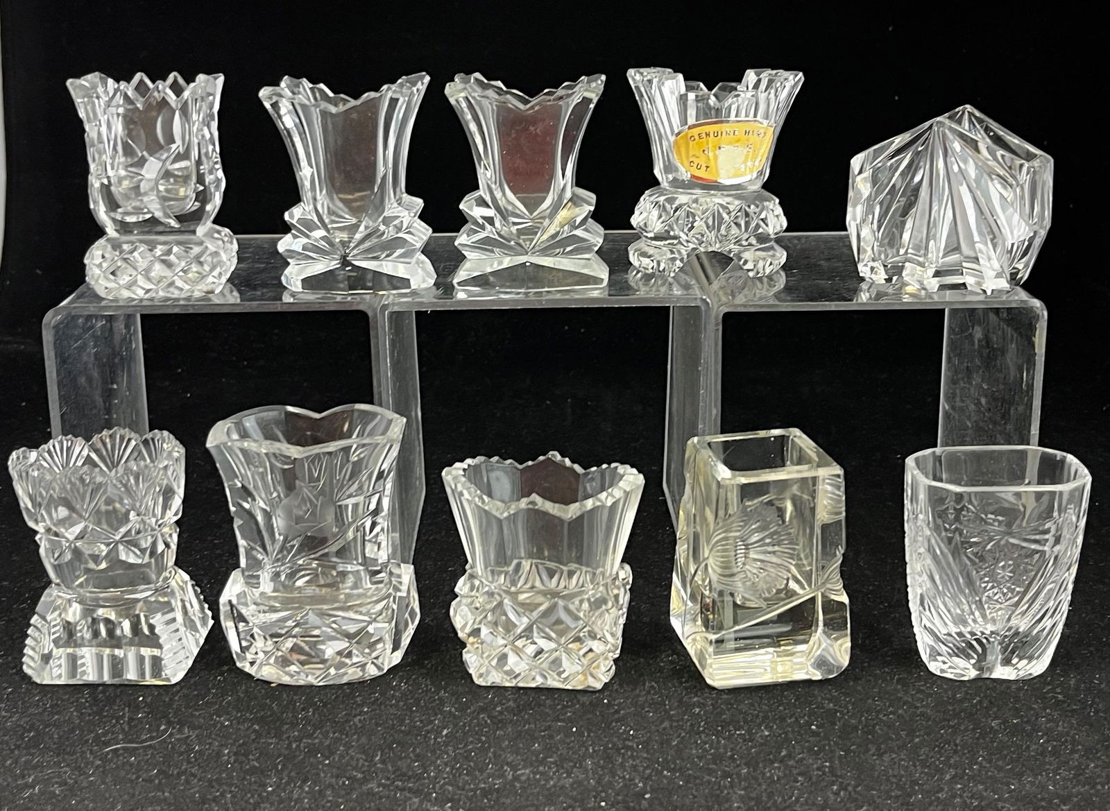 Group of 10 cut glass toothpicks: Group of 10 cut glass, oblong, and art deco toothpick holders various makers and patterns; tallest 3". CONDITION: good with minor wear.