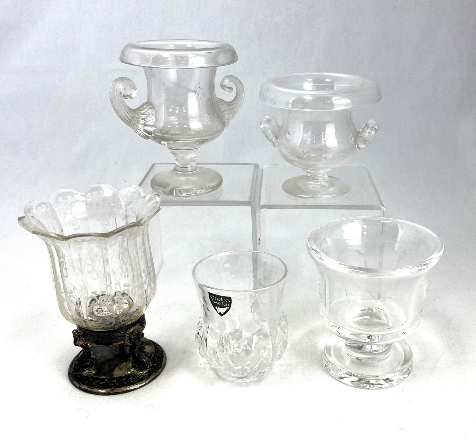 Five clear assorted toothpick holders: Five clear assorted toothpick holders, various makers and patterns including an Orrefors Sweden, an etched on metal base, a signed Steuben, and one etched with S on bottom; tallest 2 5/8". CONDITION: