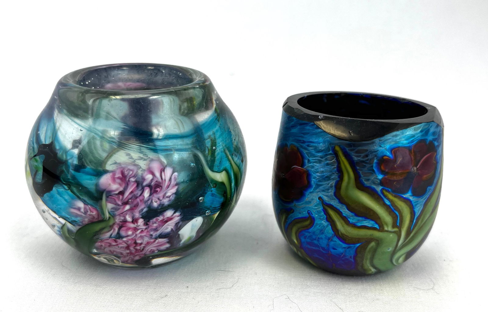 Two David Salazar toothpick holders: Two David Salazar toothpick holders one cased crystal with floral design, one blue iridescent with floral design, signed; tallest 2 1/4". CONDITION: no defects noted.
