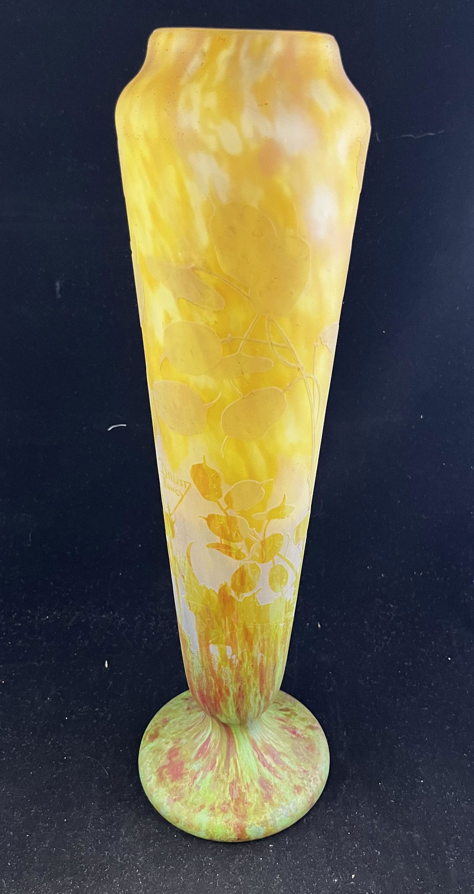 Daum Nancy French cameo glass vase: Daum Nancy footed cylindrical vase in mottle yellow and green with pink overtones decorated with a cameo carved money plant, signed in cameo Daum Nancy, 16" ht. Condition: good with no defects found.