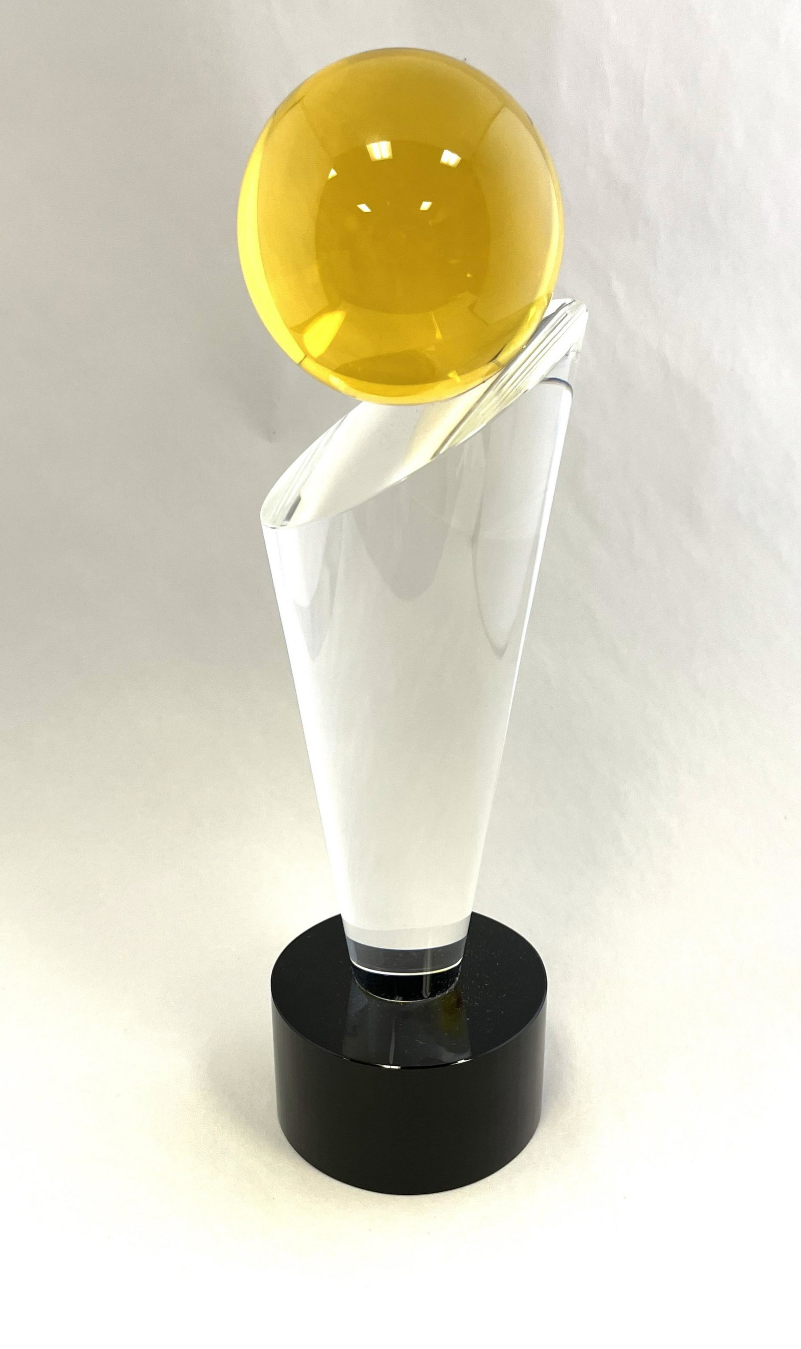 Grant Miller art glass sculpture: Black footed trophy form with a clear standard and amber ball, signed Grant Miller, 12 3/4" ht. Condition: good with no defects found.