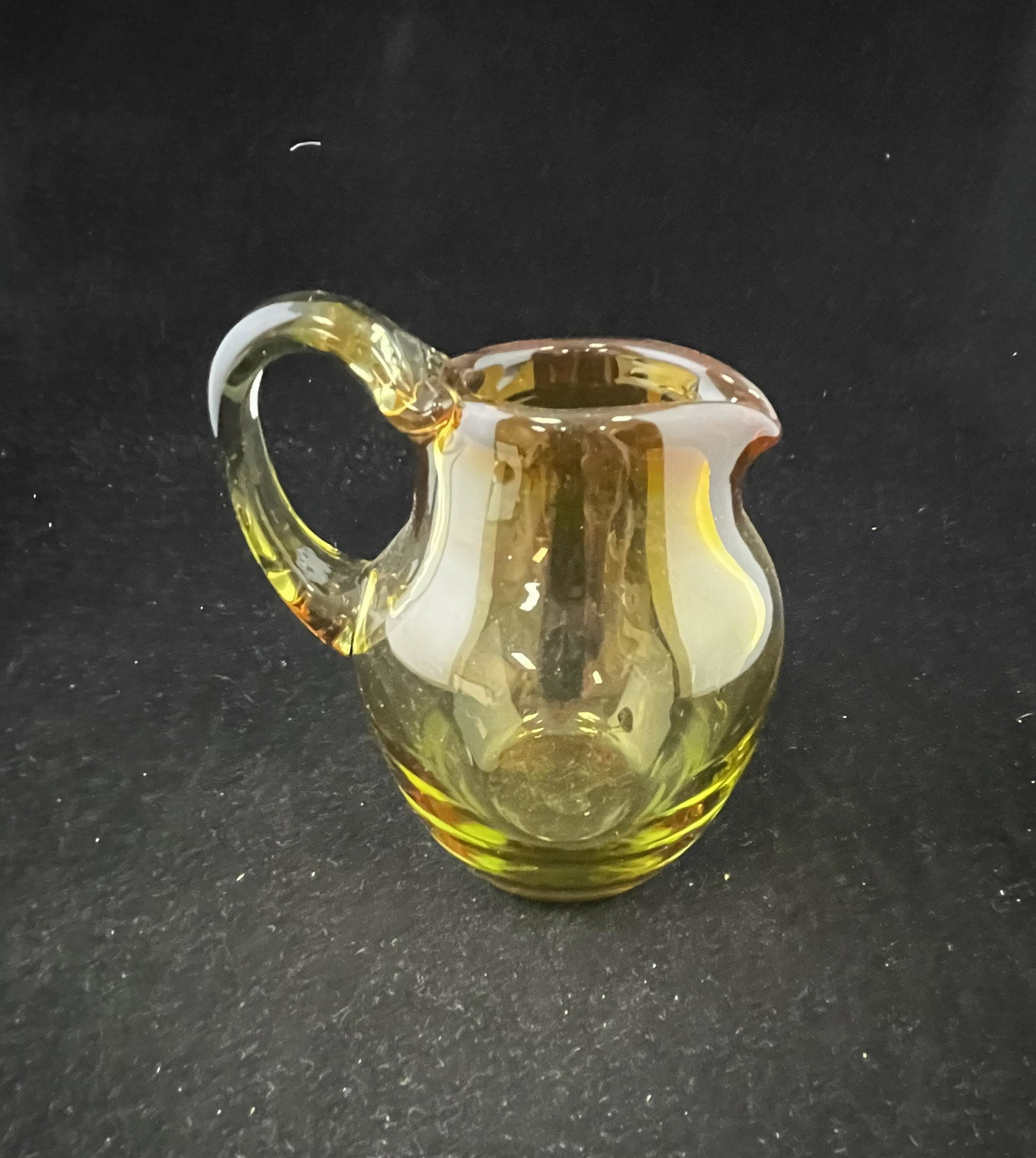 Labino art glass pitcher: Labino art glass pitcher in amber shading to rose, signed Labino 1967, 5 3/4" ht. Condition: good with no defects found.