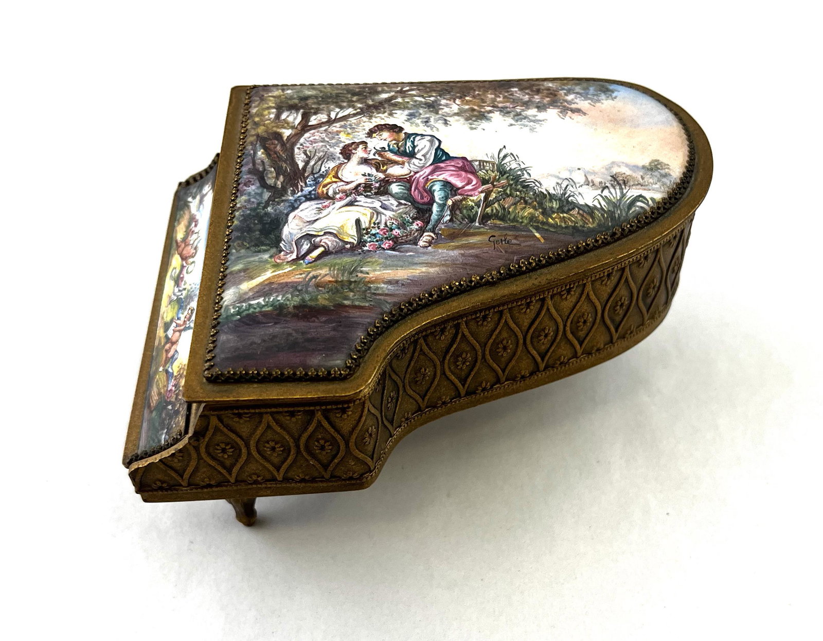 Viennese miniature enameled piano: Viennese miniature enameled on copper piano shaped music box, artist signed Gerle; 5 1/2" length; CONDITION: Good with no issues.