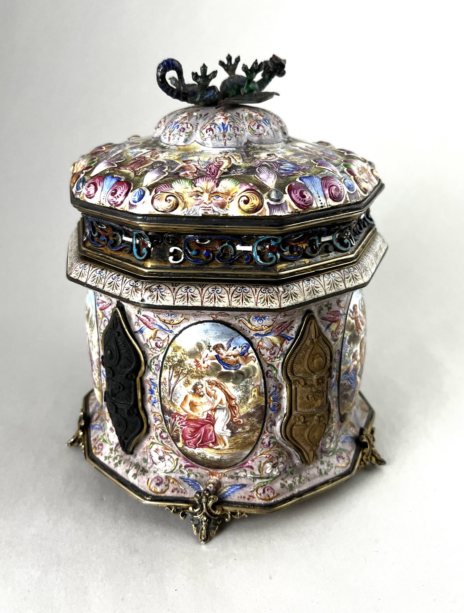 Rare Viennese Humidor: Rare Viennese Humidor with Mythological medallions and all over polychrome flowers, decorated interior and bottom with Romanesque scenes and adorn with a dragon finial, 7" ht. CONDITION: Good with no 