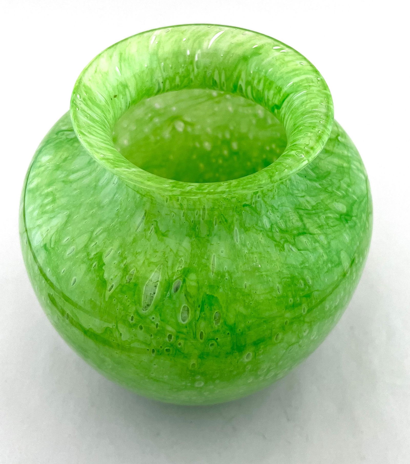 Steuben Green Cluthra glass vase: Steuben shouldered form green glass vase with a Cluthra finish, signed with a Steuben Acid stamp, 6 1/2" ht. Condition: good with no defects found.