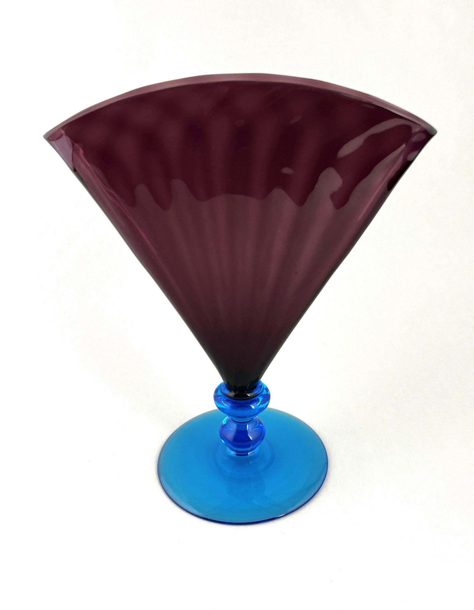 Rare Steuben fan vase: Rare color combination on this Steuben fan vases with an optic ribbed purple fan set on a Celeste blue foot, 8 1/2" ht. CONDITION: good with no defects found.