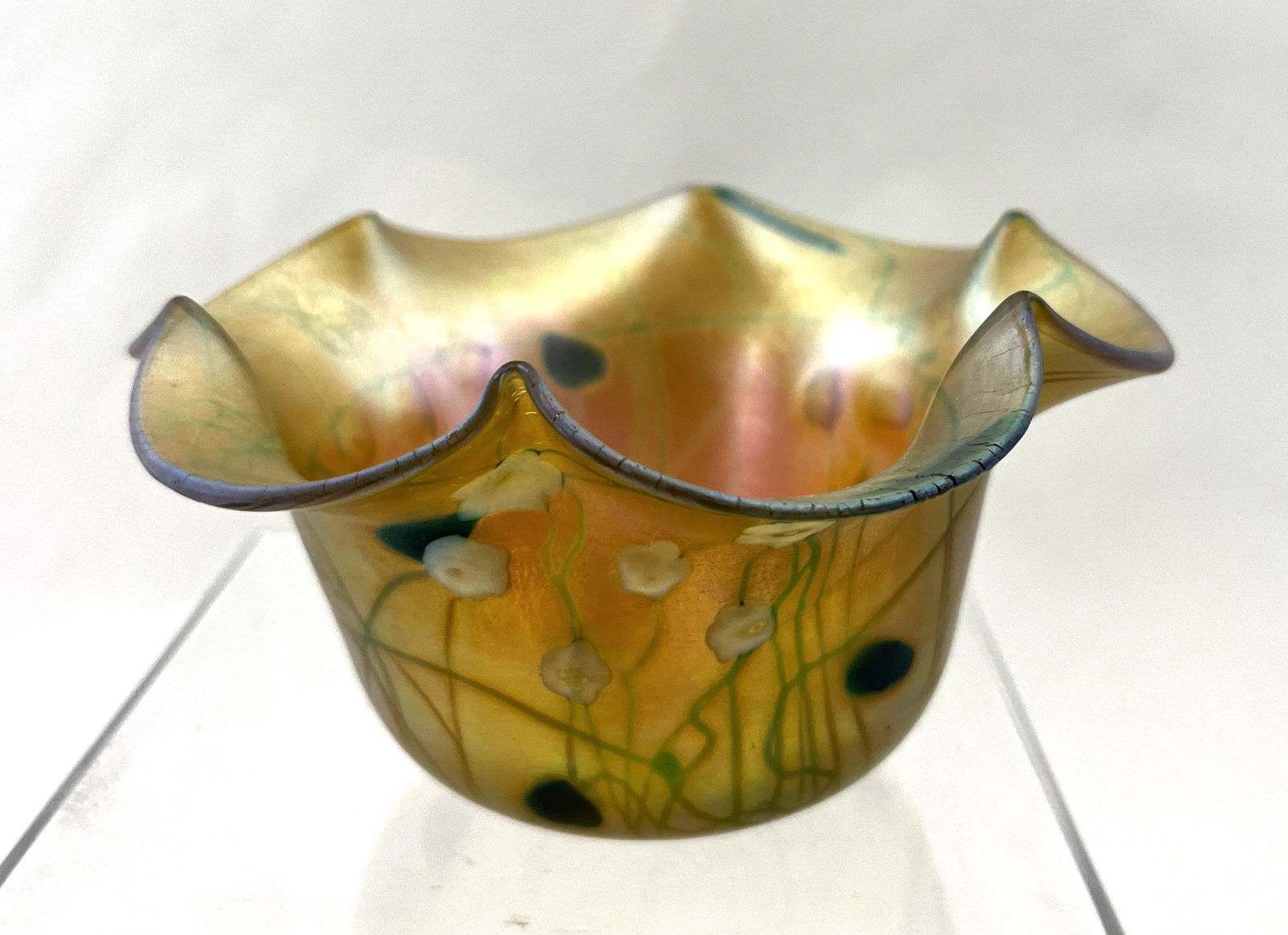 Steuben F. Carder Millefiori bowl: Steuben Gold Aurene scalloped bowl with white Millefiori and green hearts, signed Aurene F. Carder, 5" wide. CONDITION: good with no defects found.