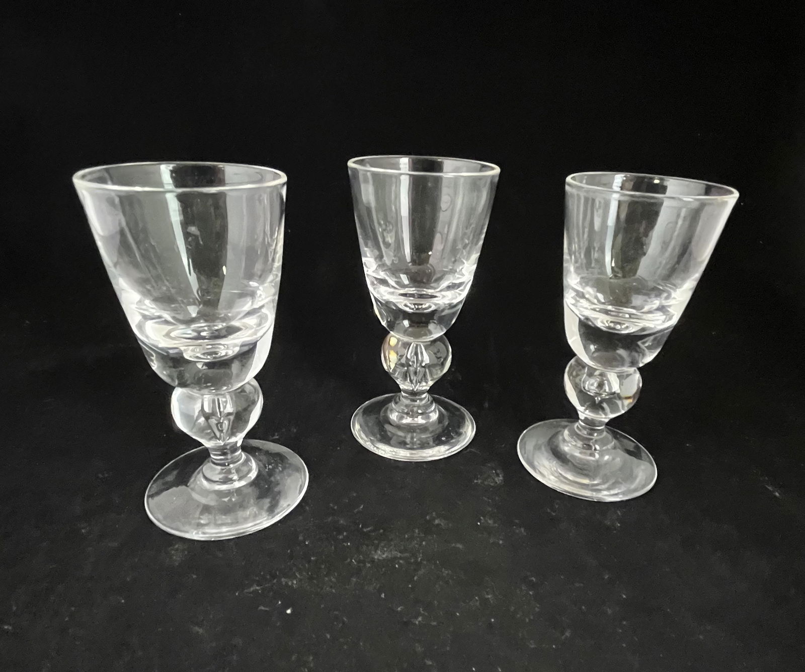 Three Steuben clear goblets: Three Steuben cordial goblets with tear drop stems, each script signed Steuben, 4 1/4" ht. Condition: good with no defects found.