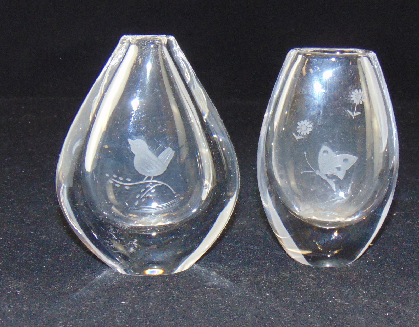 Two Swedish art glass vases: Each tear drop form in translucent glass decorated with birds and butterflies, butterfly marked Kosta, bird vase marked of Orrefors, 4 1/2" ht. Condition: good with no defects found.