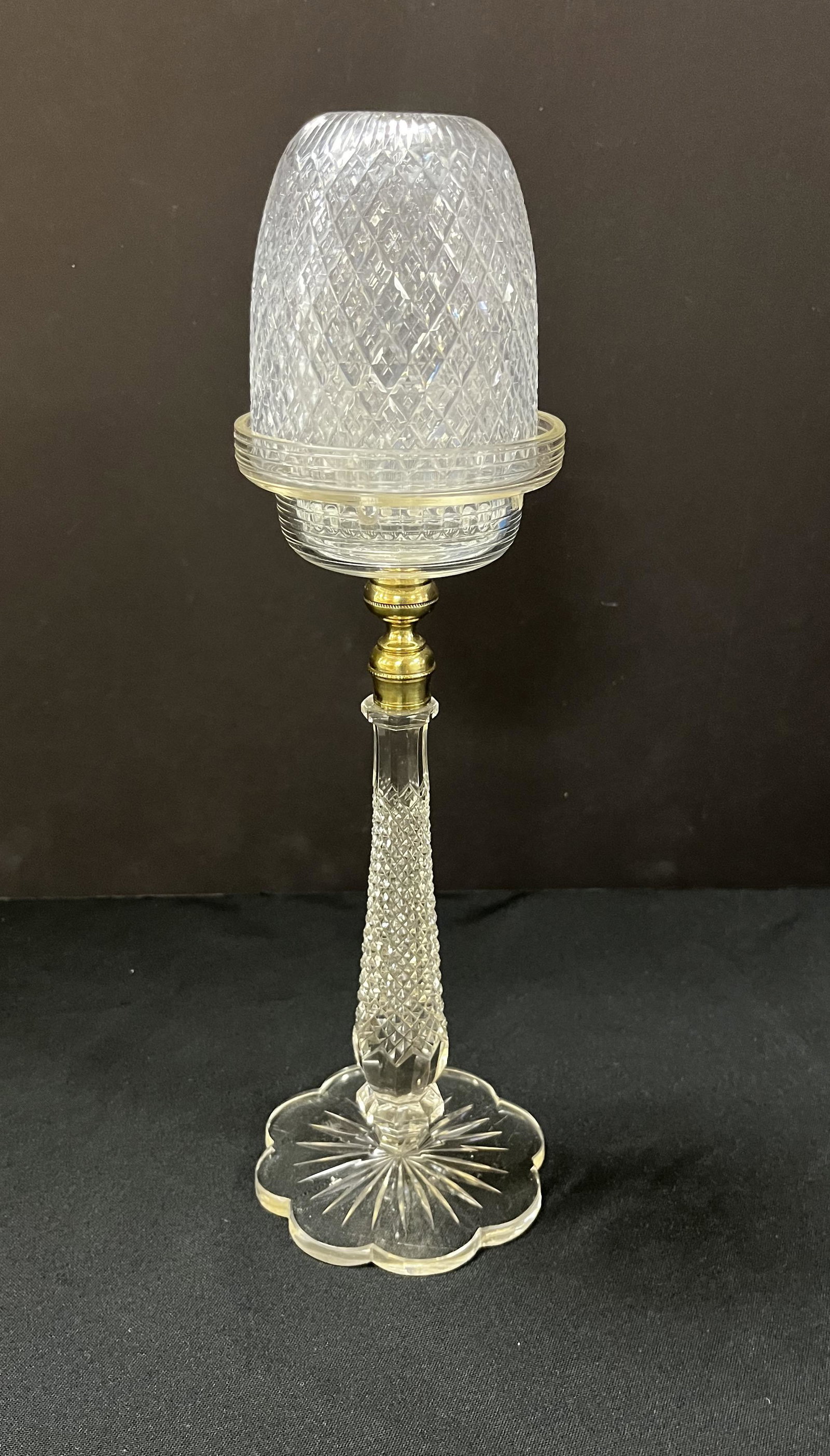 Cut glass Fairy lamp: Cut glass stemmed standard with brass fitting carries a pressed glass fairy in the four in one diamond pattern, 14" ht. Condition: good with slight roughness on the top of the shade, see picture.