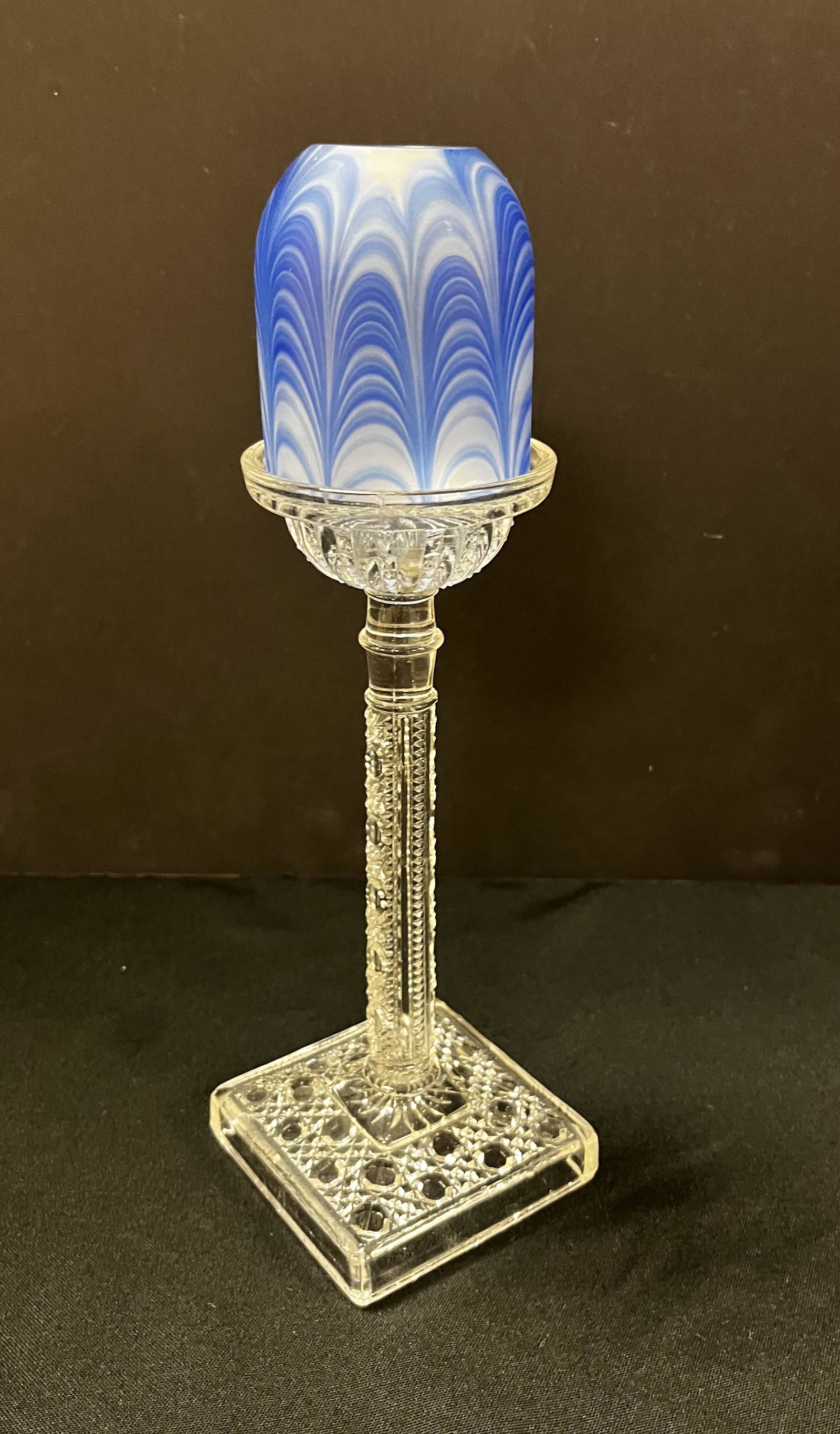 Blue Nailse pedestal fairy lamp: Blue frosted Nailsea fairy lamp shade set on a Hobstar and cane pattern pressed glass base, 11 1/2' ht. LITERATURE: see "Fairy Lamps by Ruf page 209 Condition: Good with no defects found.