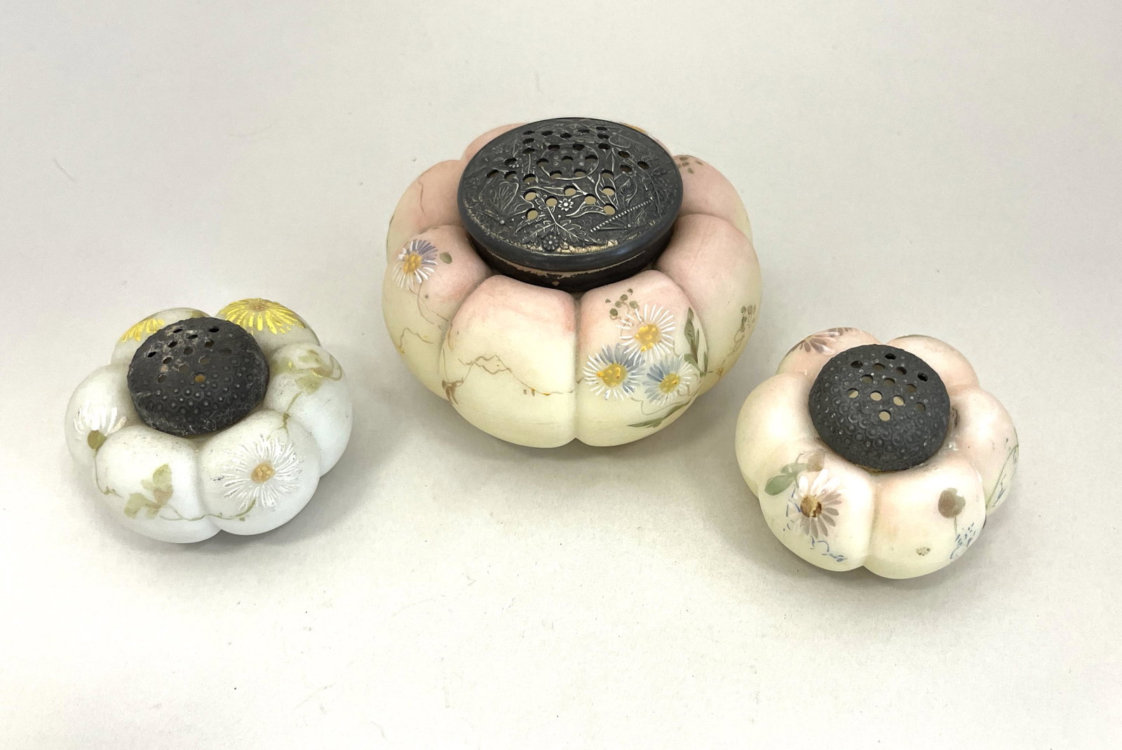Mt. Washington shaker set: Mt. Washington shaker set consisting of a sugar shaker in Burmese color and two salts each with daisies, sugar 3 1/2" wide. CONDITION: good with no defects found.