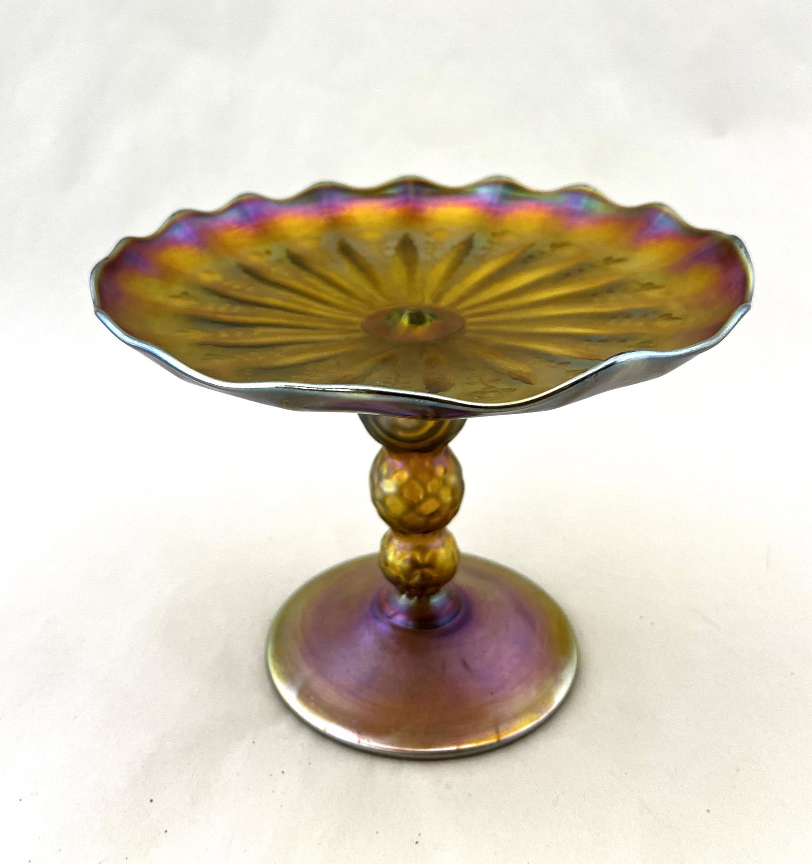 Nash intaglio cut compote: Nash Gold Favrile compote with a honeycomb standard decorated with an intaglio cut tray with acanthus leaves and flowers, marked Nash, 5 1/2' ht. CONDITION: good with no defects found.