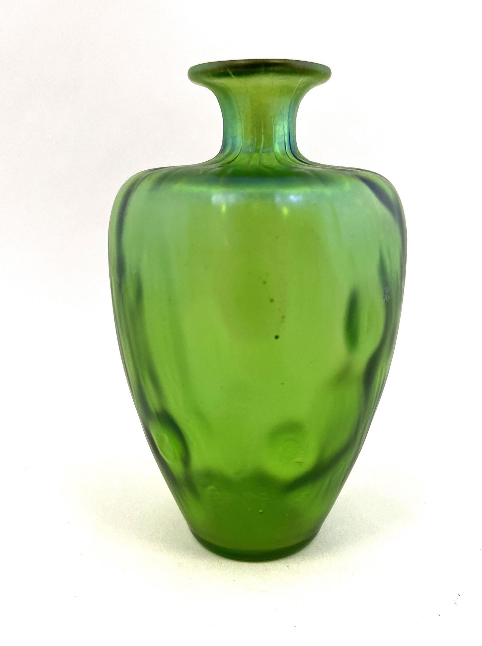 Loetz Rusticana glass vase: Loetz Rusticana bottle form vase in iridescent green glass, 5" ht. CONDITION: Good with no defects found