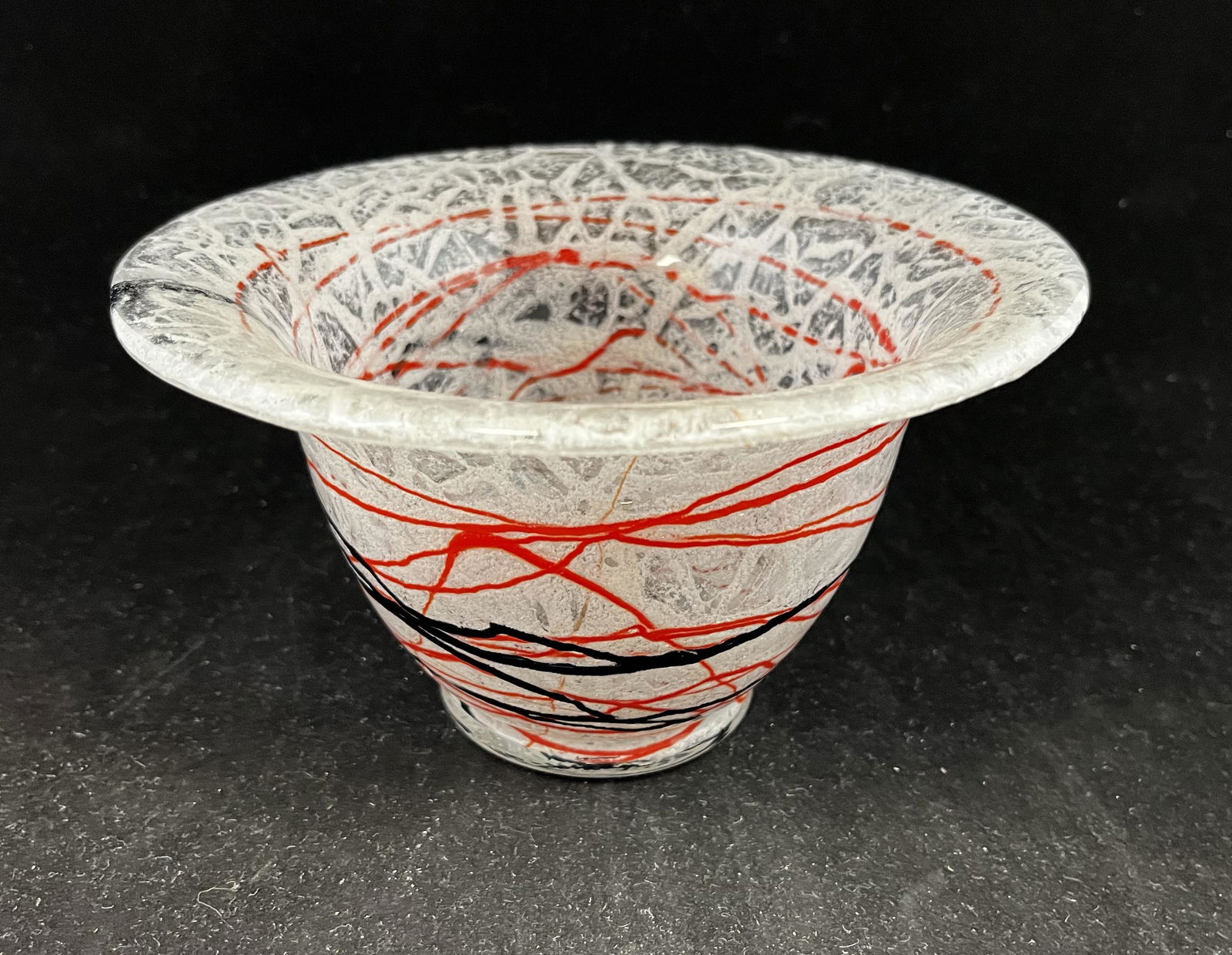 Loetz Schaumglas glass bowl: Loetz Schaumglas bowl in clear and white mottled glass decorated with red and black threading, 7" wide. PROVENANCE: Ernest Albanese. CONDITION: Good with no defects found.