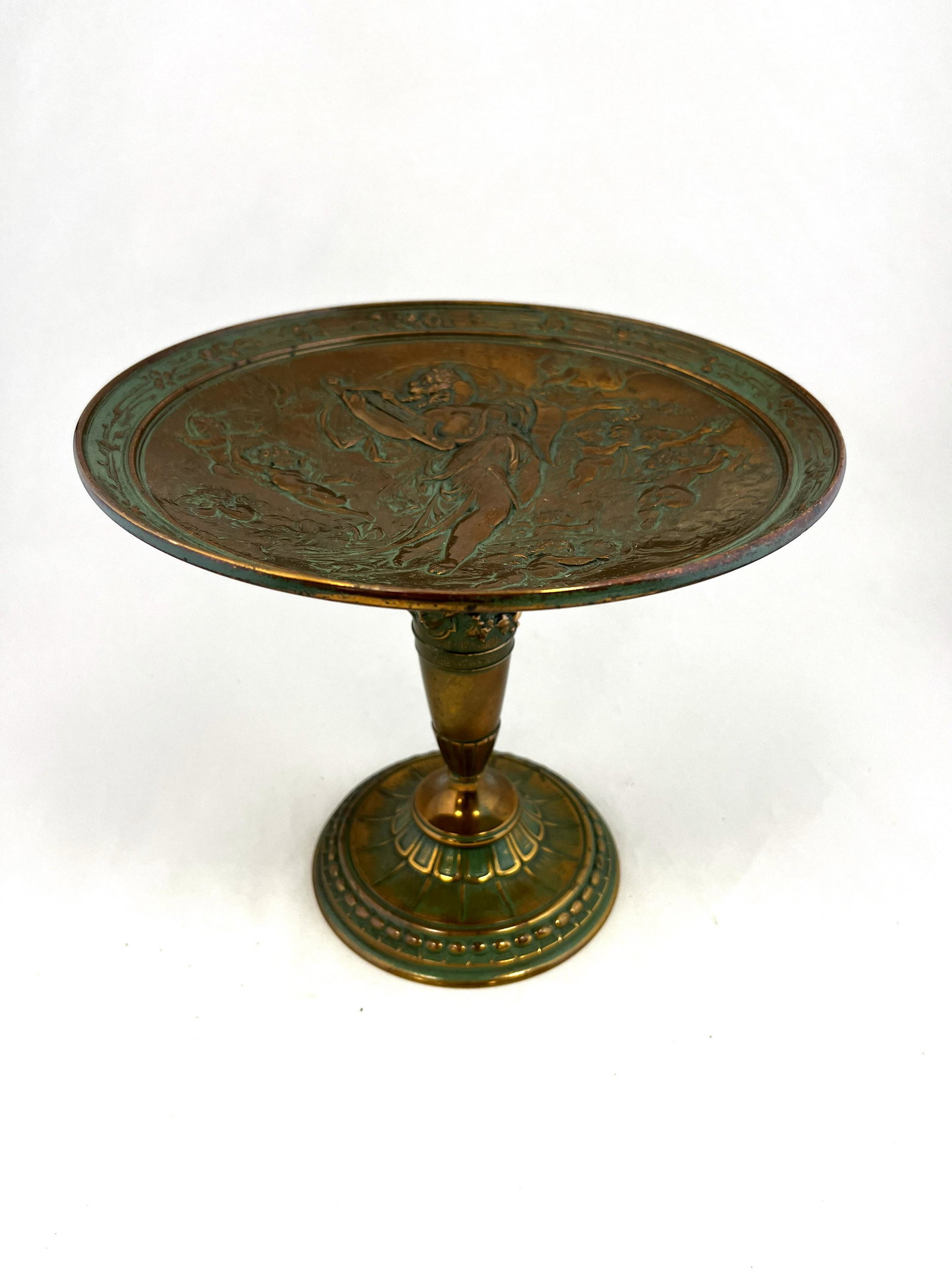 Tiffany and Company bronze compote: Tiffany and Company bronze compote decorated with a semi nude with harp surrounded with cherubs, double mask standard with green and gold patina, marked Tiffany & Co. 7 3/4" ht. CONDITION: good with n