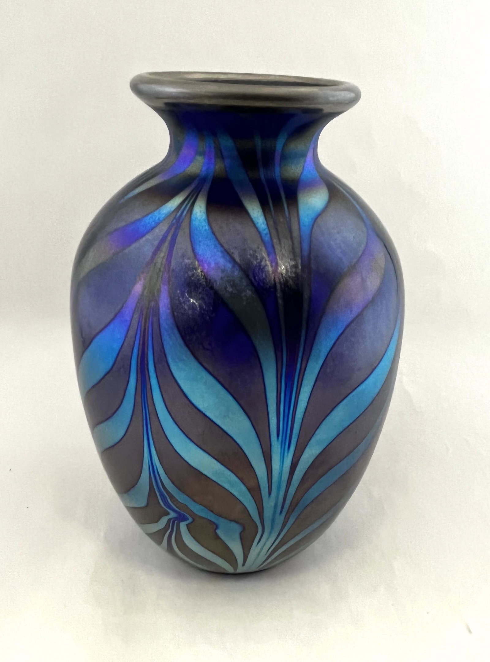 David Fetty Fenton art glass vase: David Fetty designed art glass vase in iridescent blue with a pulled feather designed for Fenton, signed, 8 1/2" ht. CONDITION: Good with no defects found