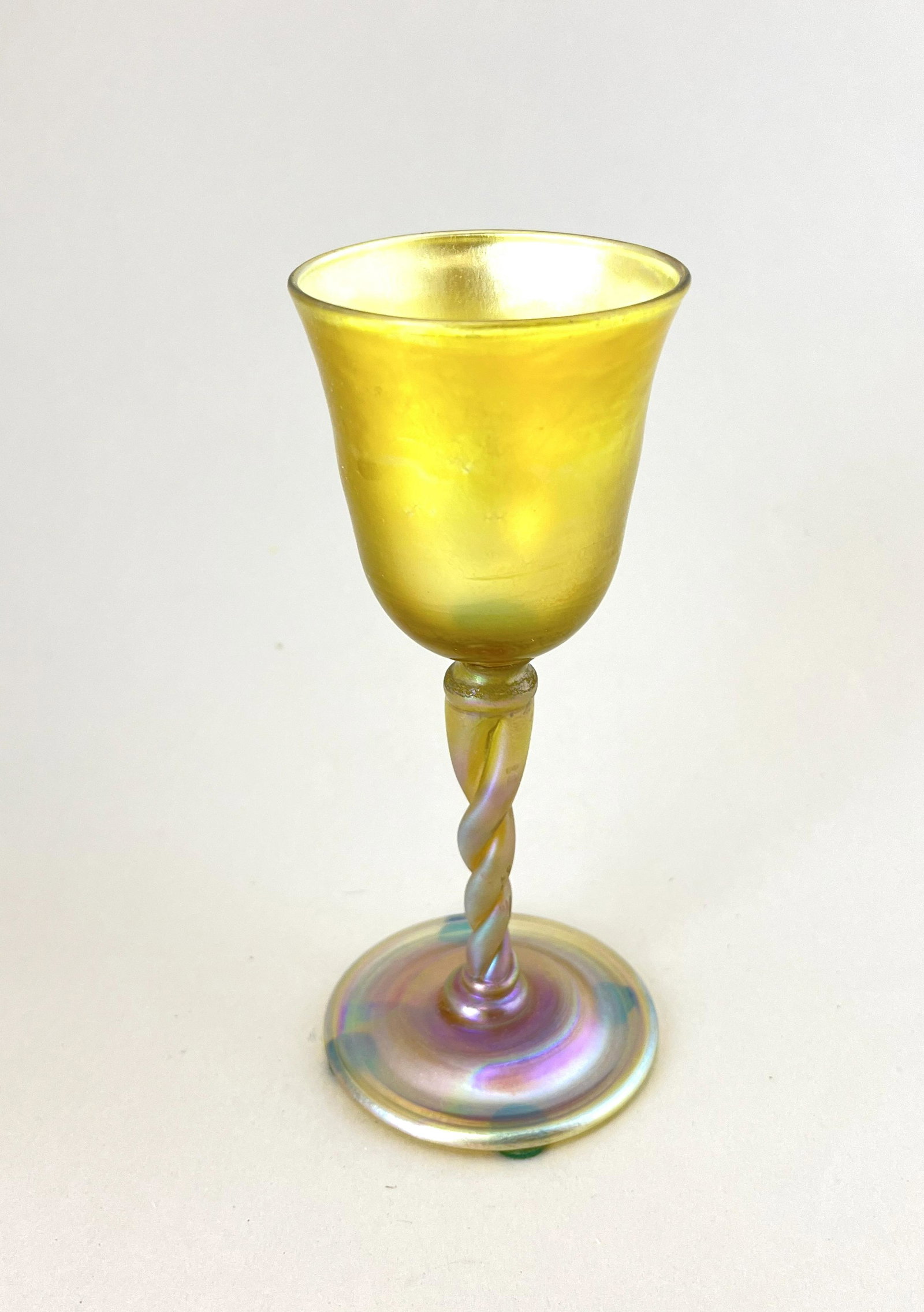 Tiffany Gold Favrile stemmed goblet: Tiffany Gold Favrile twist stem goblet, signed LCT, 5 3/4" ht. CONDITION: Good with no defects found.