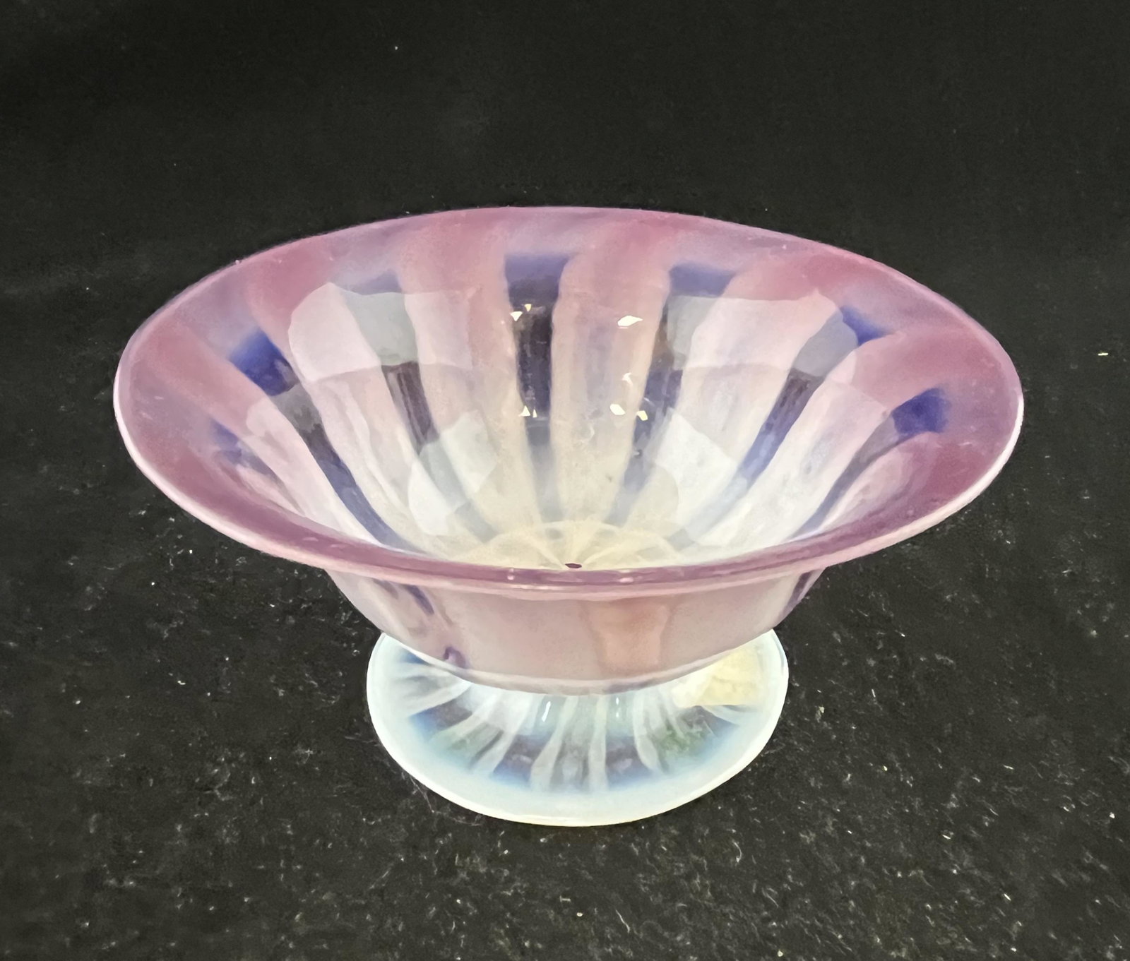Tiffany purple Pastel footed sherbet: Tiffany Pastel opalescent purple footed sherbet signed L. C Tiffany Favrile, 4 3/4" wide. CONDITION: Good, bubble and embedded ash to the interior.