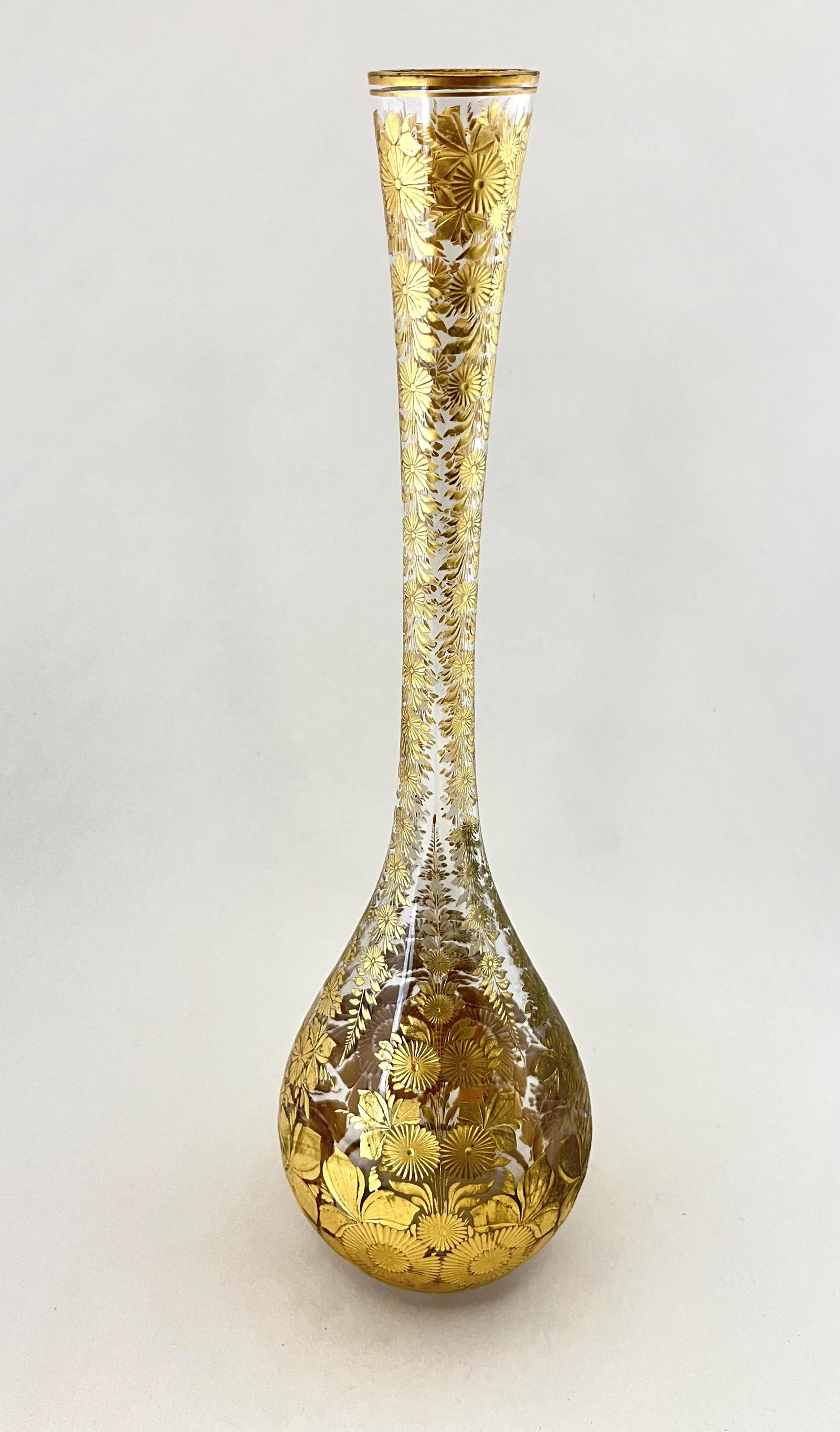 Gold intaglio Moser stick vase: Clear glass bottle form with gold intaglio flowers, 13" ht. CONDITION: Good with no defects found