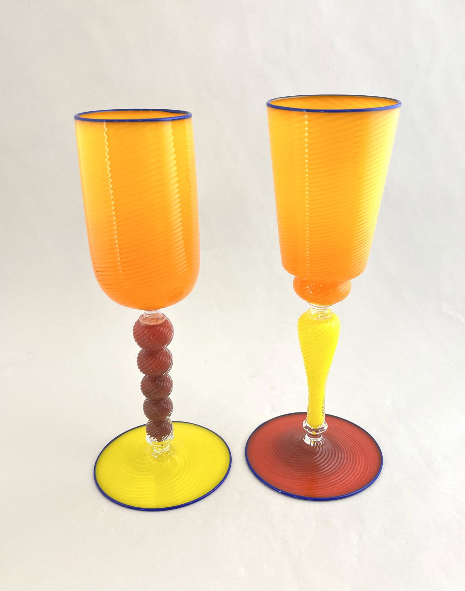 Two Dante Marioni Art glass goblets: Two Dante Marioni art glass goblets in bright pastel colors each signed, 9" ht. CONDITION: both with repaired stems.