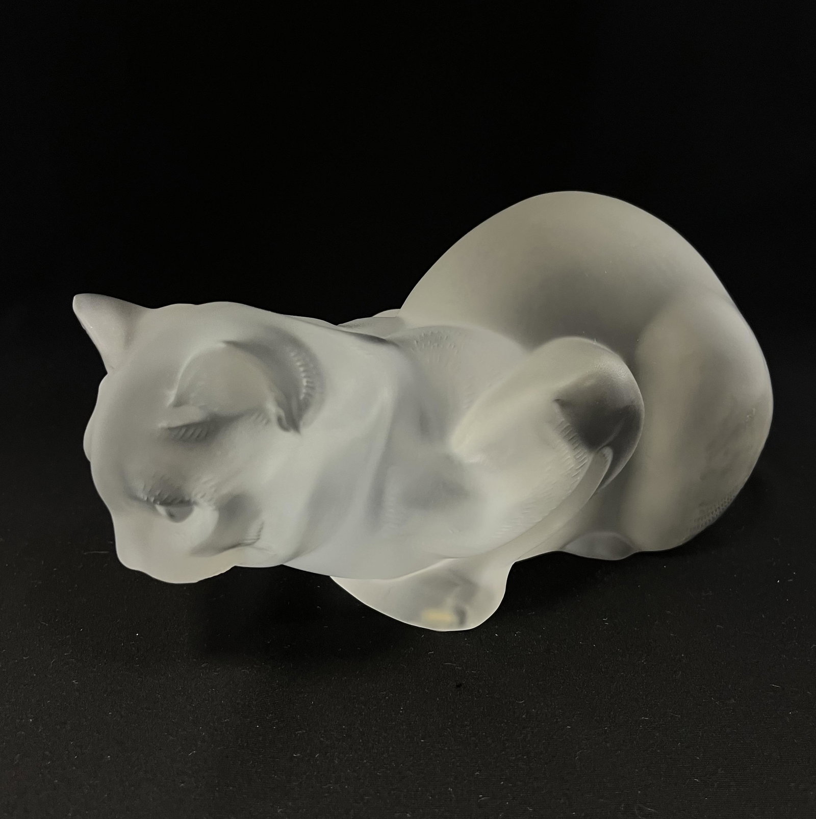 Lalique figural cat: Lalique frosted cat in a seated prone position, signed Lalique France, 9" long CONDITION: no chips, cracks, repairs or material defects found. Jaremos attempts to call any material flaw but minor scra