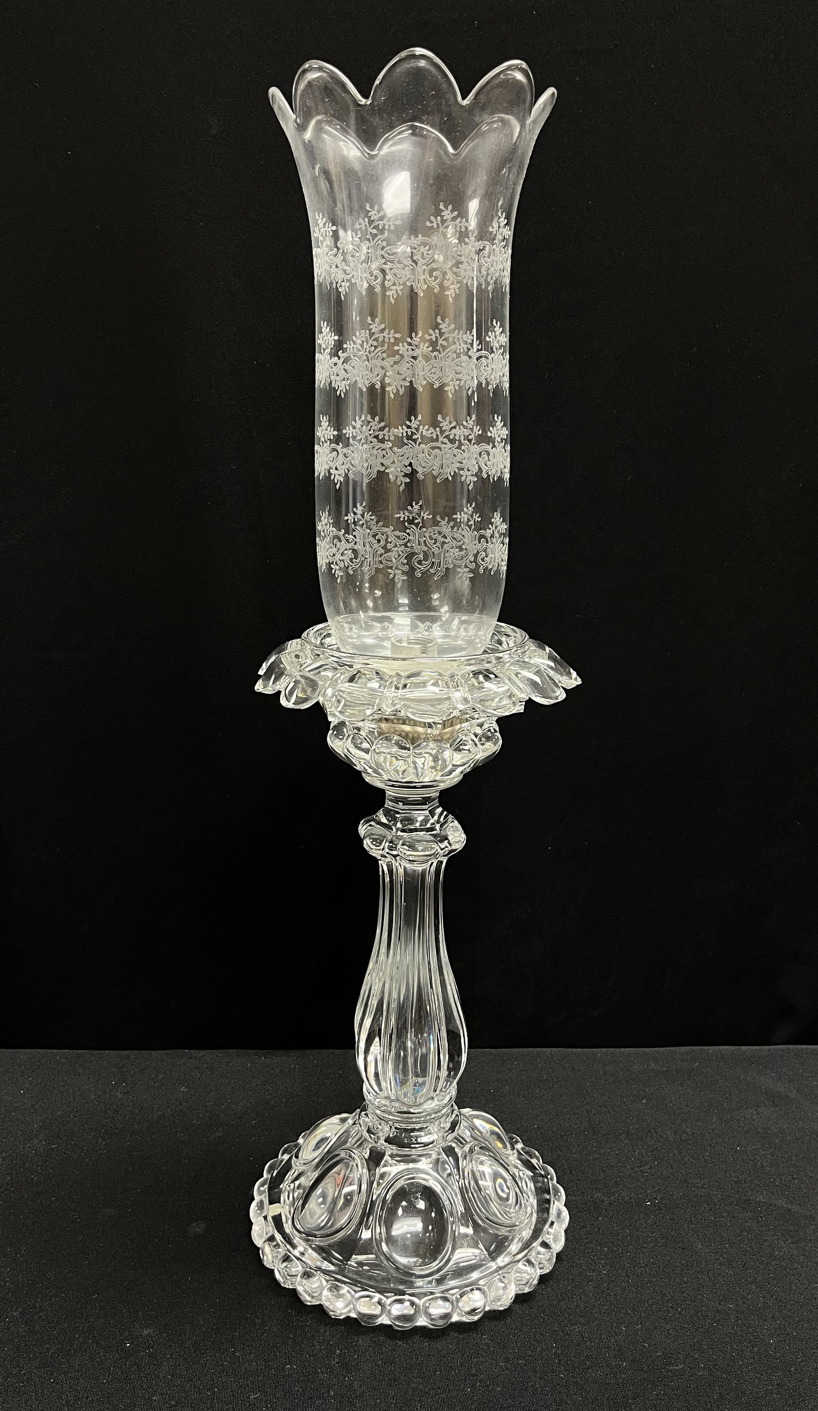 Baccarat mantel lamp: Baccarat three part mantel lamp consisting of a candle base with bobeches and scrolling etched shade all three parts signed with factory stamp, 22" ht. CONDITION: no chips, cracks, repairs or material