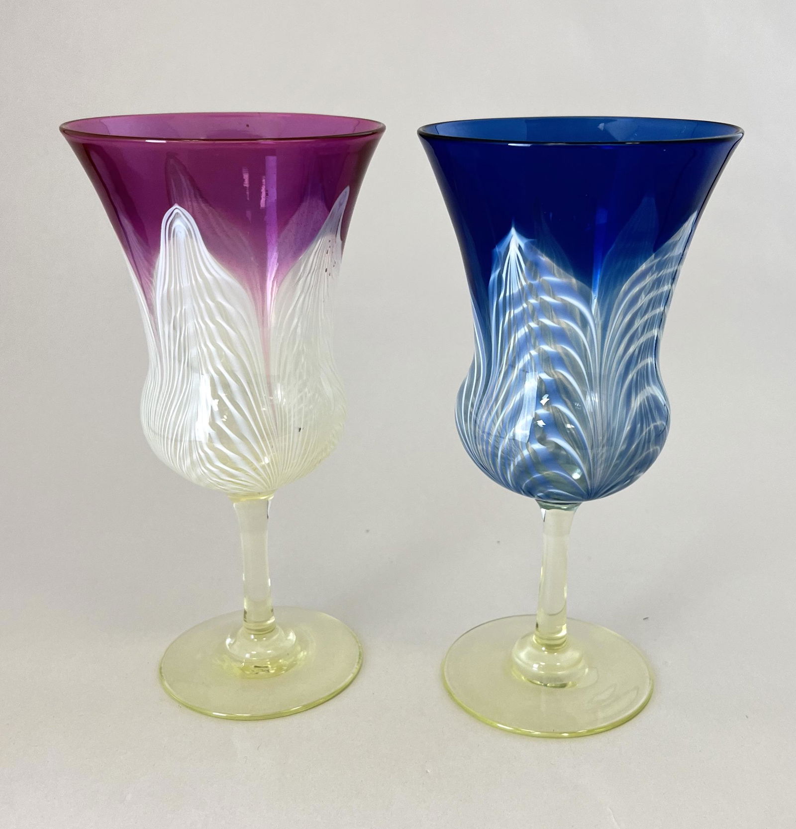 Two Durand ambergris goblets: Two Durand ambergris goblets, on purple and one blue; 6 1/2" ht. CONDITION: no chips, cracks, repairs or material defects found. Jaremos attempts to call any material flaw that affects the price but m
