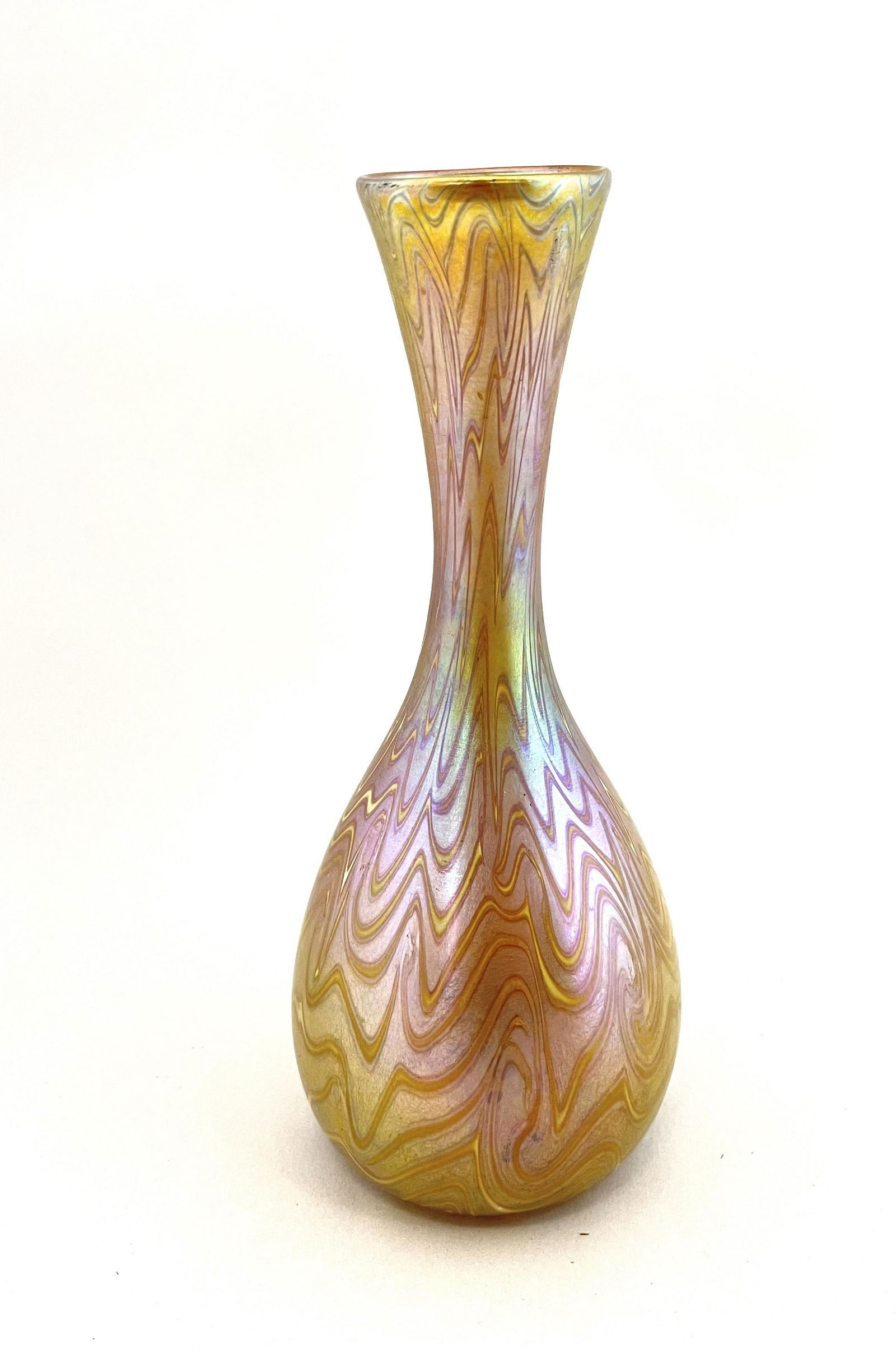 Quezal gold vase: Quezal bottle form gold iridescent vase with white hooked feather, signed Quezal; 8 1/2" ht. CONDITION: no chips, cracks, repairs or material defects found. Jaremos attempts to call any material flaw